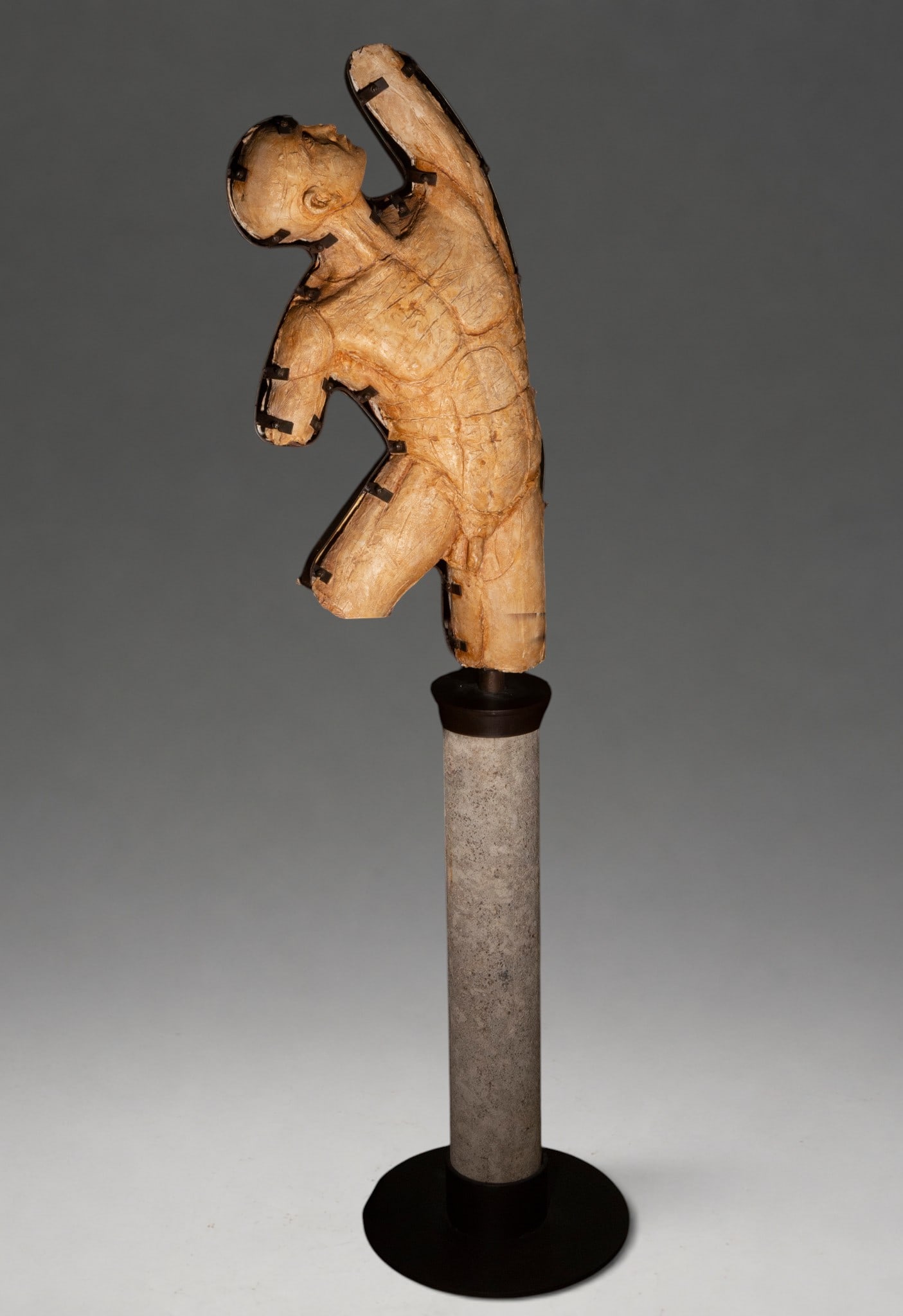 Male torso, signed “F. Seguí?? – late 20th century-early 21st century: Contemporary male torso sculpture made of wood, iron, and epoxy resin. The figure appears fragmented at the arms and legs, with one arm raised and deliberately textured carved and modeled surfaces. Th
