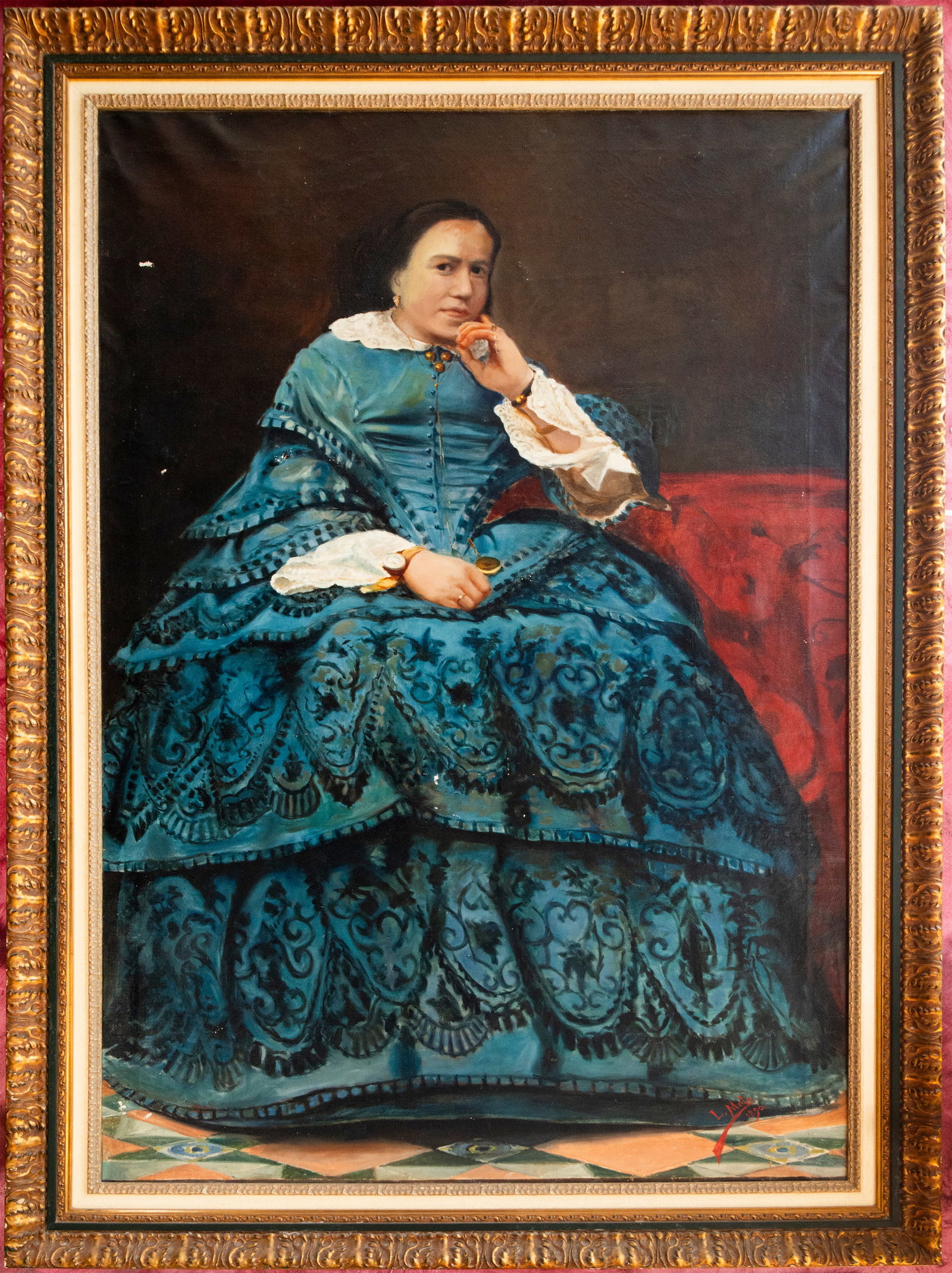 Portrait of a lady, signed “L. Melo?? – 1890: Oil on canvas. Full-length portrait of a lady seated indoors, wearing a flowing turquoise dress with elaborate decoration and white lace. She rests one arm on a red upholstered chair and wears various