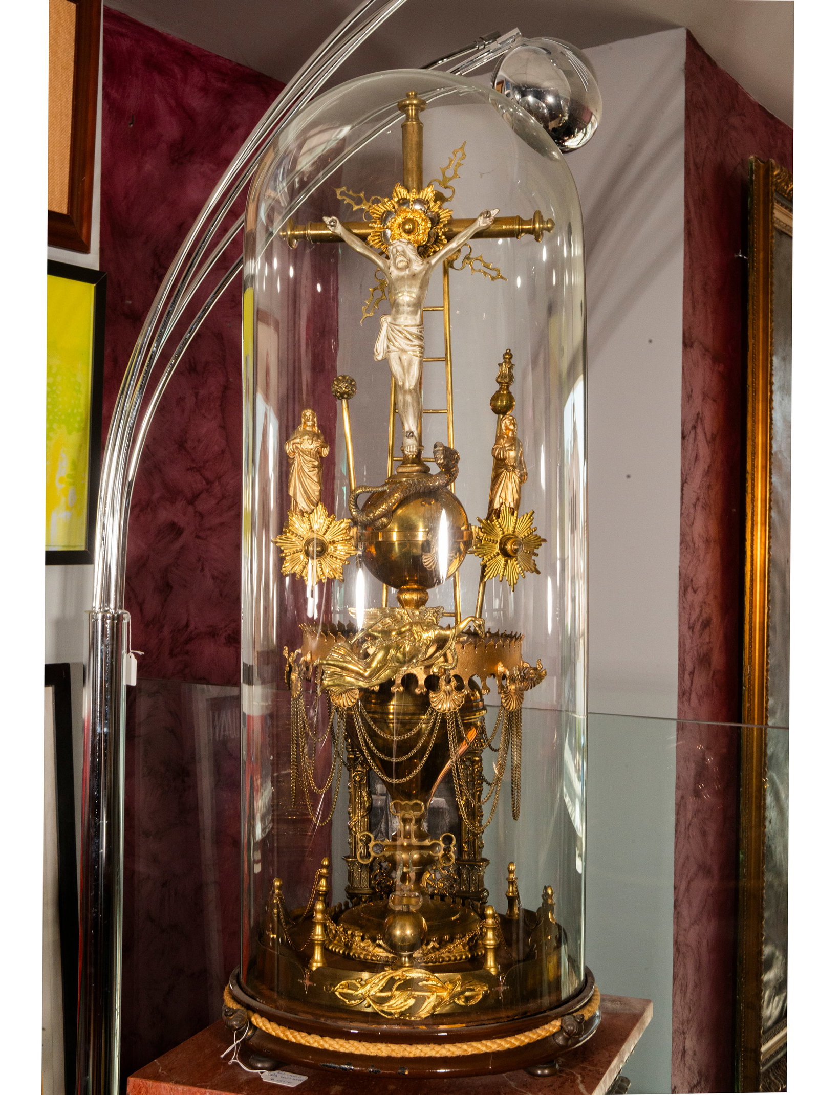 Devotional reliquary of the Passion of Christ – Germany – late 19th century: A large, devotional composition in a historicist style, displayed under a glass dome, centered around a silver-plated crucifix on a gilded cross. The structure incorporates various symbols and instrum