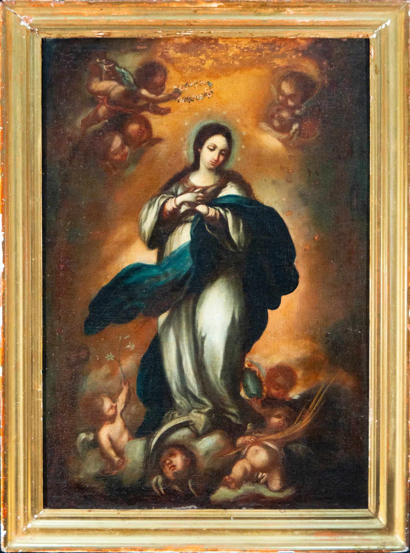 Immaculate Conception – Spanish School – 18th century: Oil on canvas. Depiction of the Immaculate Conception, with the Virgin standing, her hands clasped over her chest, dressed in a white tunic and a wide blue-green mantle. She appears elevated on a sphe