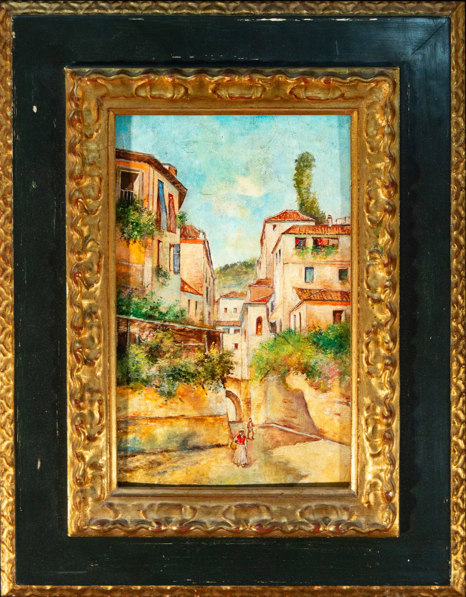 Granada city view – Spanish School – early 20th century: Oil on panel. Urban view typical of Granada, featuring stepped vernacular architecture, tiled roofs, and small figures in the foreground. The composition is notable for its luminosity and the detailed