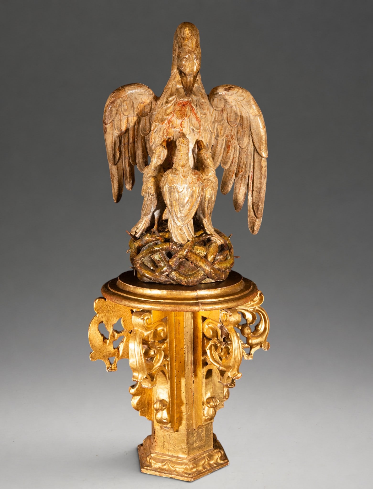 Allegory of the Eucharist - Italian Baroque Sculpture of the 17th Century: Carved, polychromed, and gilded wood. Sculptural group of Christian iconography representing a pelican feeding its young with its own blood, a traditional symbol of Christ's sacrifice and the Eucharis