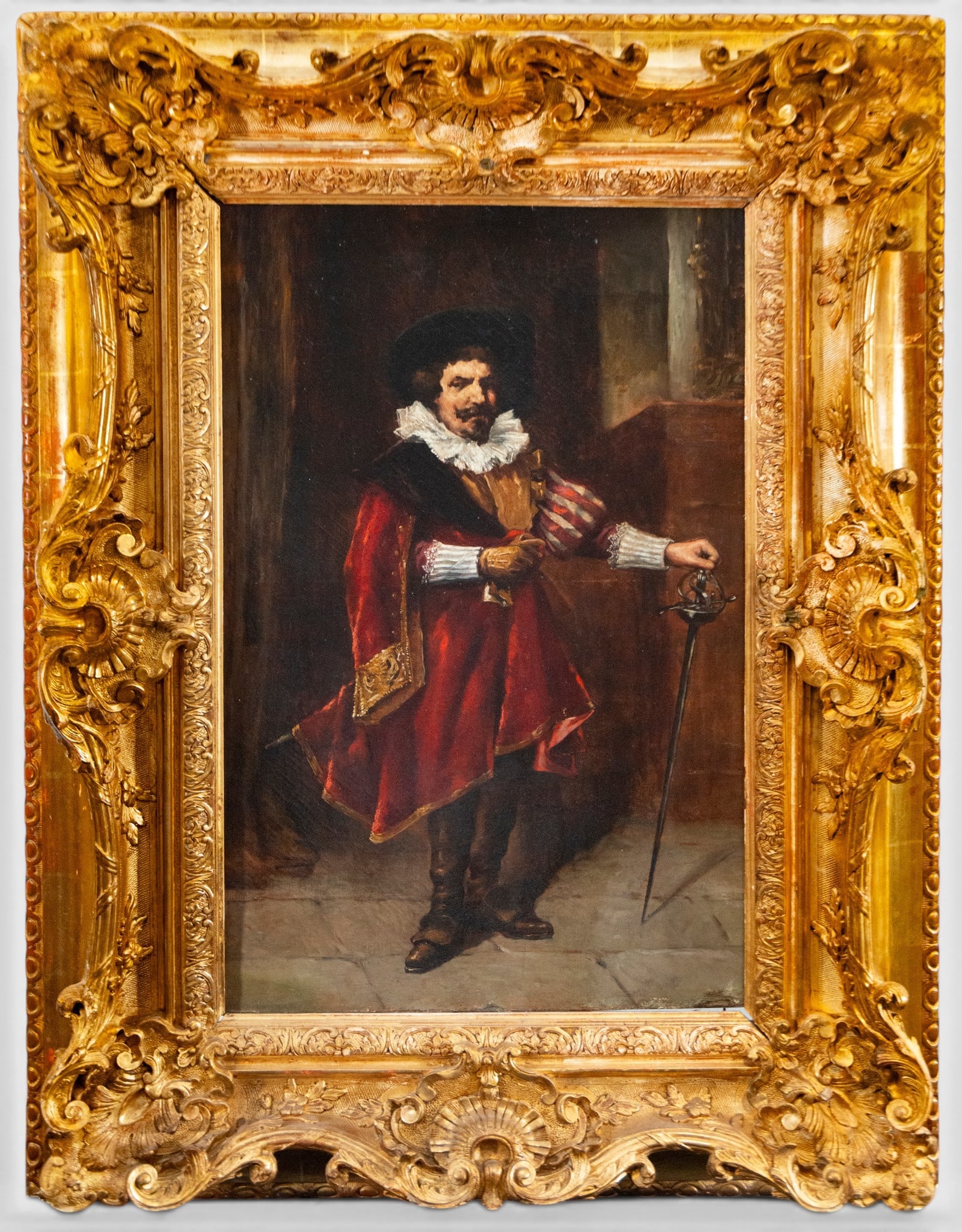 Portrait of a gentleman with a sword – French School – 19th century: Oil on canvas. Dimensions: 66 × 40 cm; with frame: 95 × 70 cm. Full-length portrait of a gentleman dressed in 17th-century fashion, with a white ruff, cloak, and doublet in shades of red and black. 