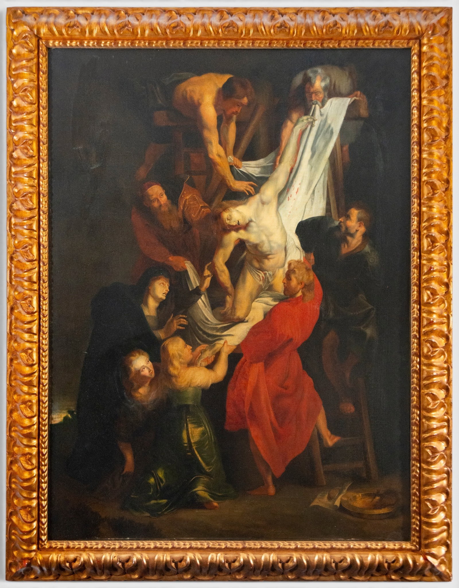 Descent from the Cross – Flemish School – 18th century: Oil on canvas. Measurement: 129 × 97 cm; with frame: 152 × 117 cm. Scene of the Descent from the Cross, in which Christ's body is supported and lowered from the cross by several figures using a larg
