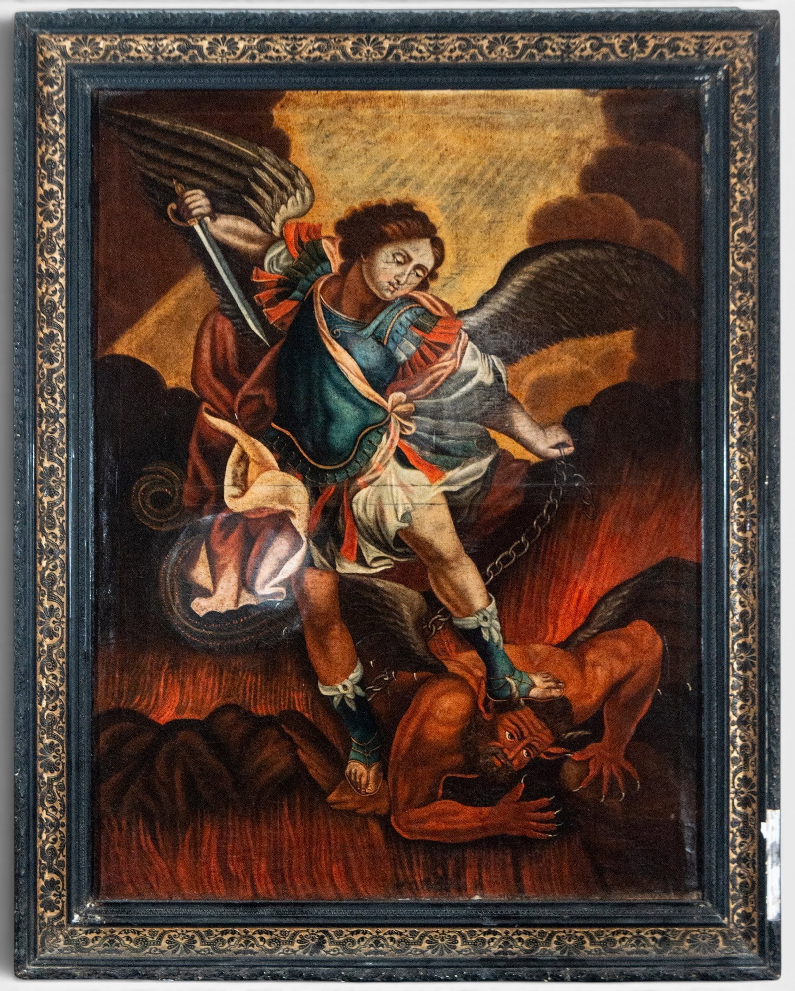 Saint Michael the Archangel defeating the devil – Colonial School – 17th century: Oil on canvas depicting Saint Michael the Archangel triumphant over the devil. The archangel appears winged, dressed in military attire, wielding a sword in his right hand and holding a chain in his l