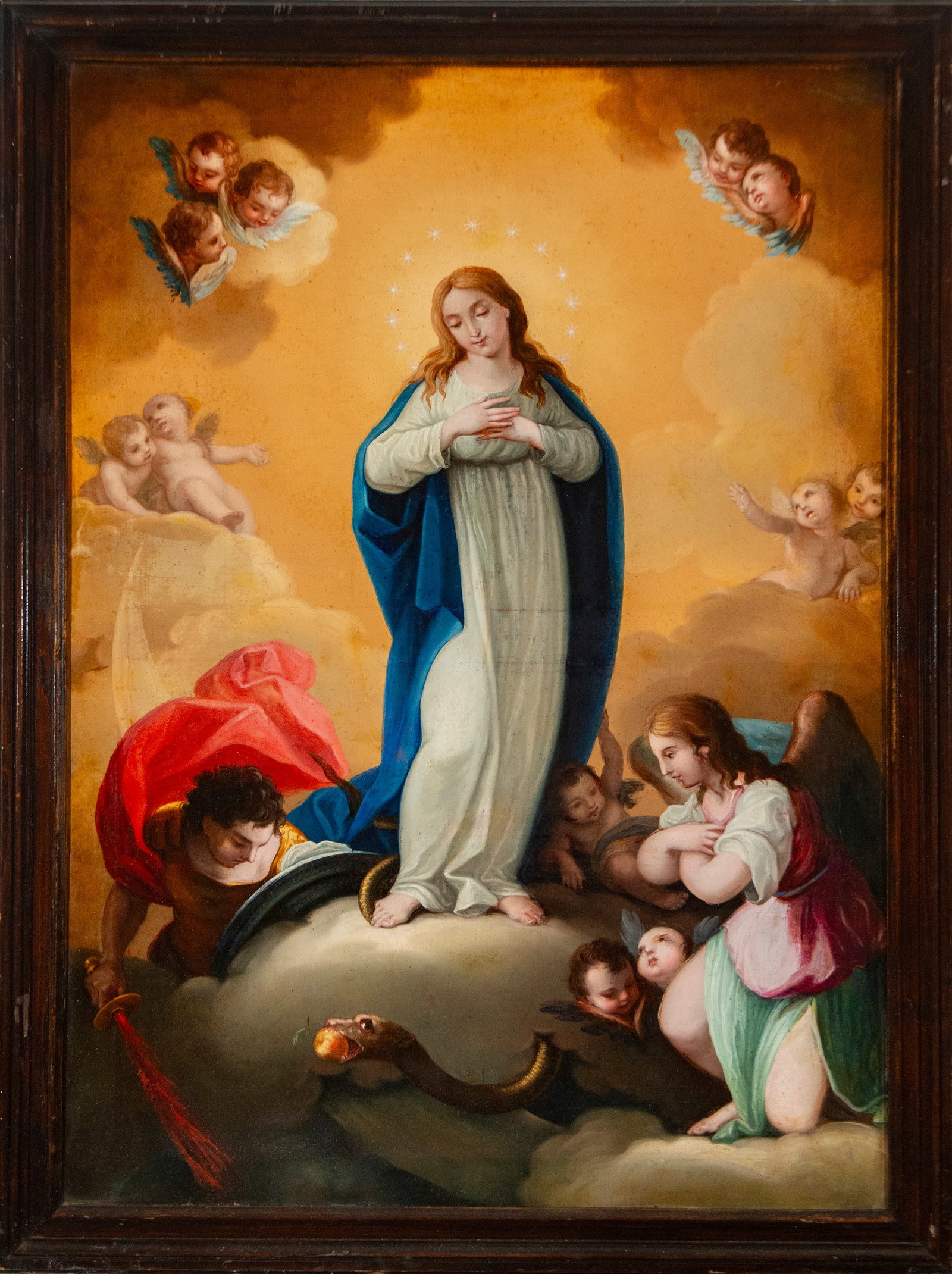 Immaculate Conception with Angels – Spanish School – 18th Century: Oil on canvas depicting the Immaculate Conception, standing on the globe and the serpent, with her hands crossed over her chest and surrounded by angels and cherubs among clouds. The Virgin wears a wh