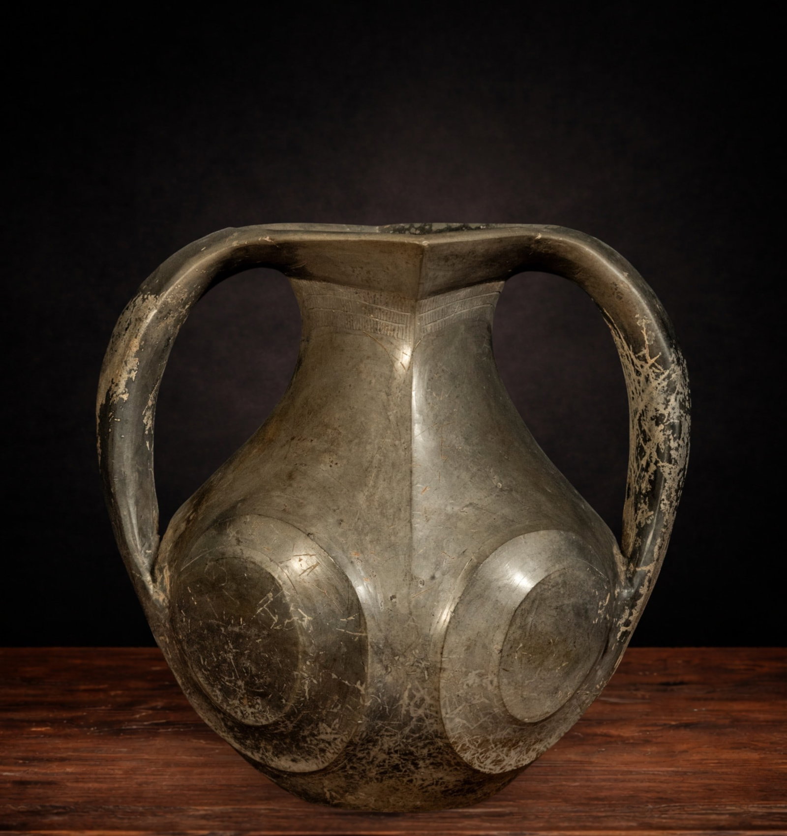 Important Han Vase - Ancient China - Chinese Art - Han Period: The Rotating Eye Vessel, made of lead-colored terracotta and dating to the Han Period (202 BC – 220 AD), is an exceptional example of the ceremonial ceramic repertoire developed during one of the mo