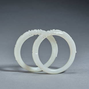 A pair of white jade 'dragon' bangles,Qing dynasty,inner diameter 6cm: A pair of white jade 'dragon' bangles,Qing dynasty,inner diameter 6cm ,total weight 90g .For size details please refer to the marks on our pictures.