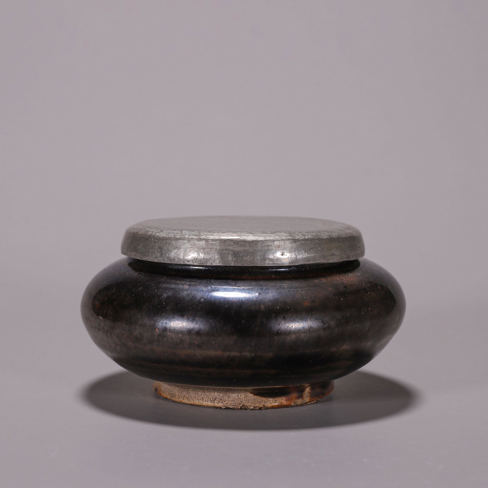 A black glazed porcelain jar with silver lid (1 of 10)