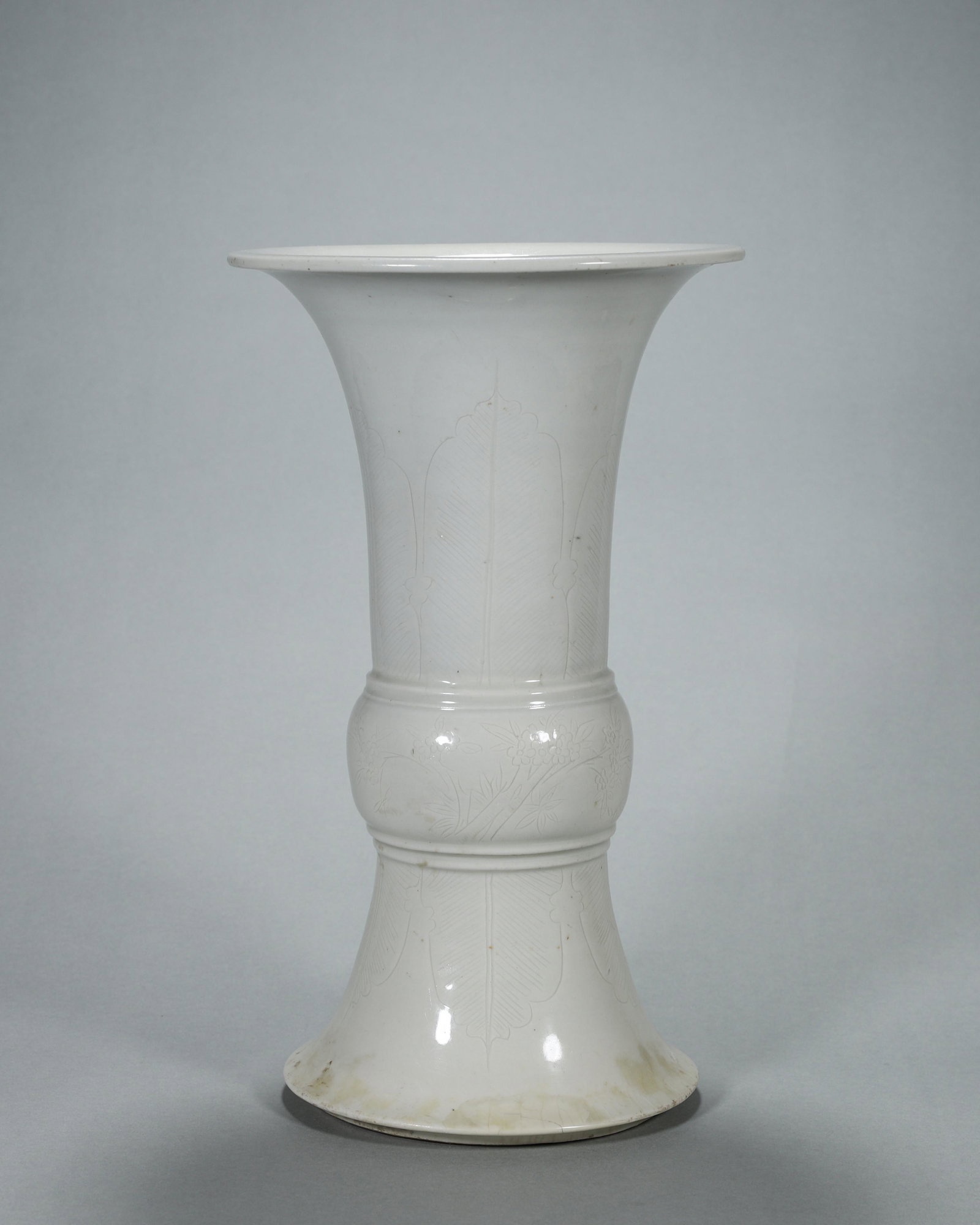 A banana leaf and flower carved white glazed porcelain beaker vase (1 of 10)