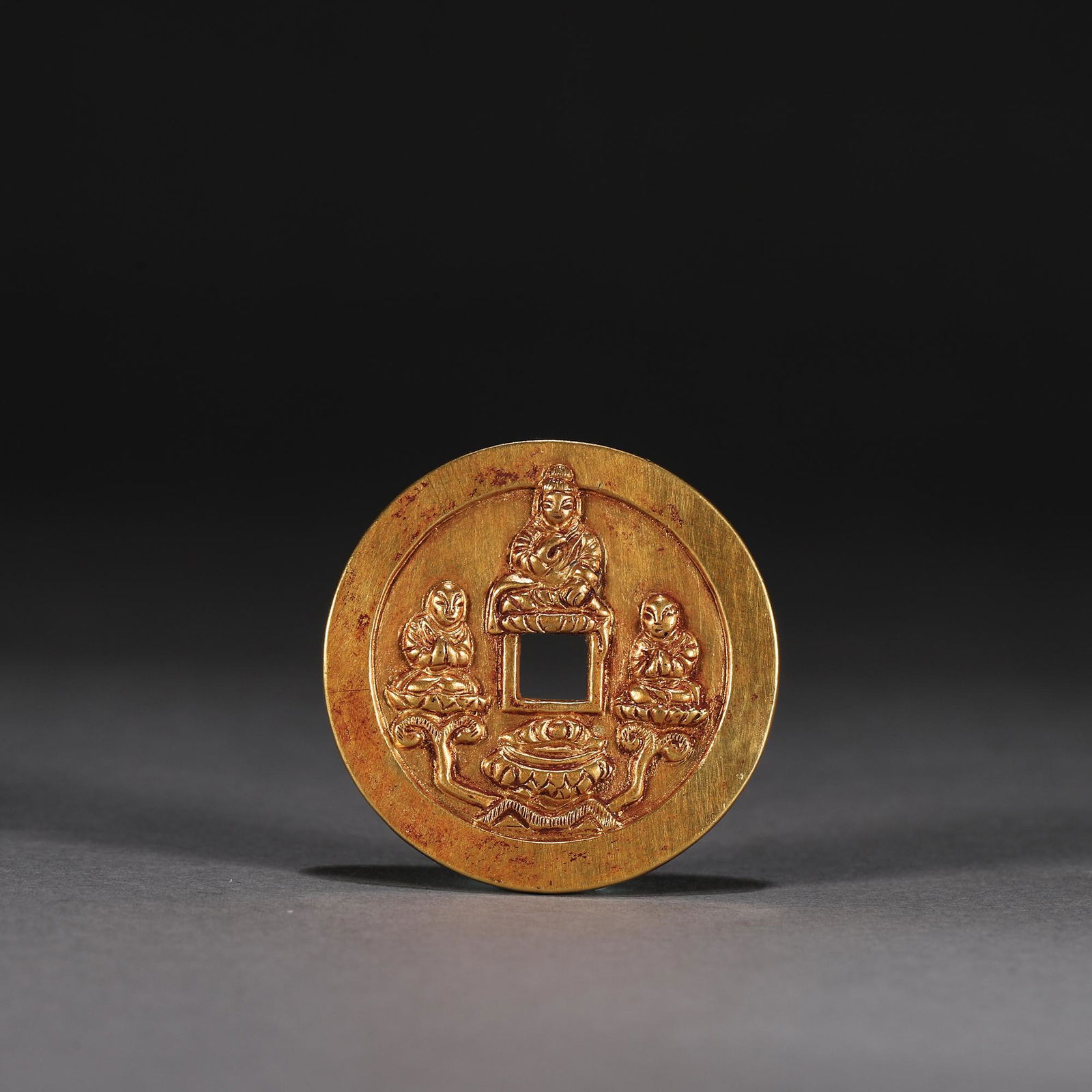 A buddha patterned gold coin (1 of 7)