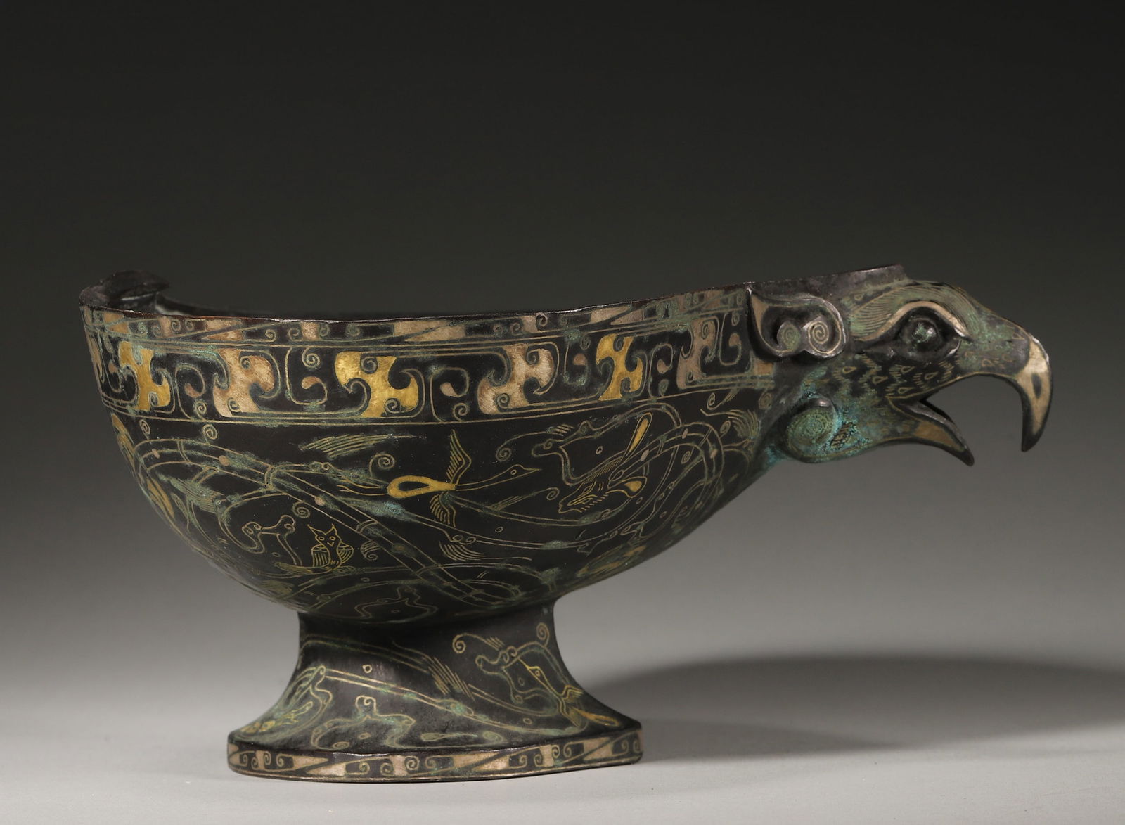 A gold and silver-inlaid bronze phoenix head pot,Han Dynasty,China (1 of 8)