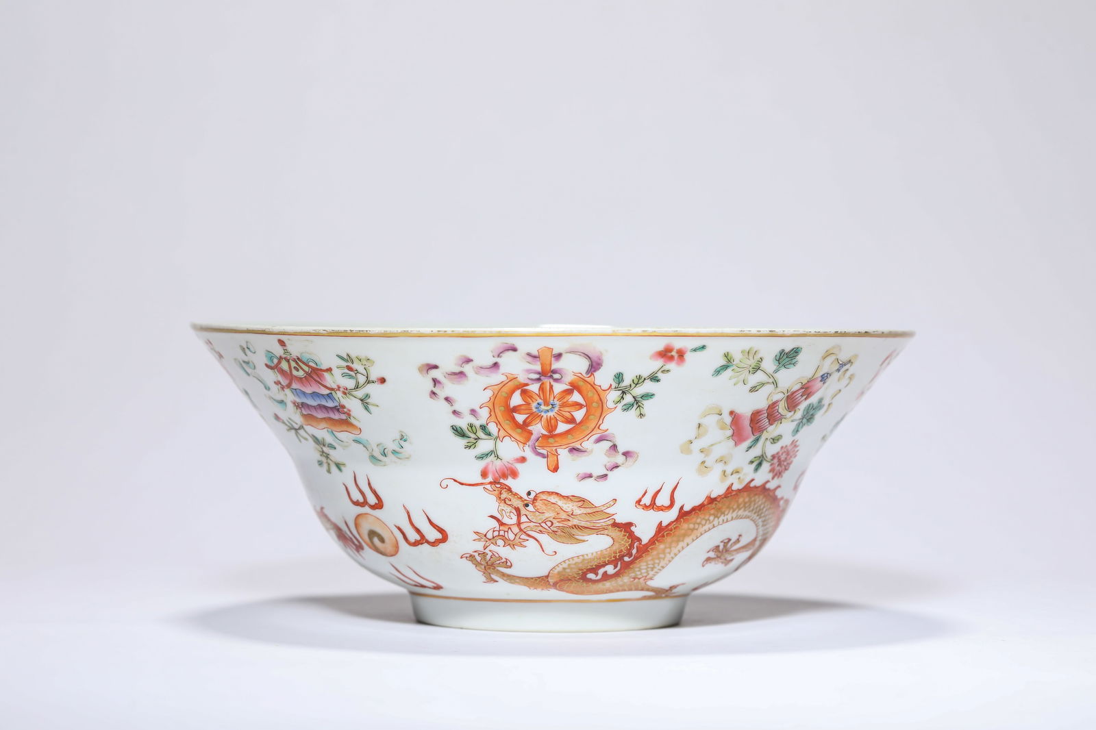 A famille rose with gilt-decorated 'Dragon Chasing Pearl and Eight Buddhist Emblems' bowl (1 of 7)