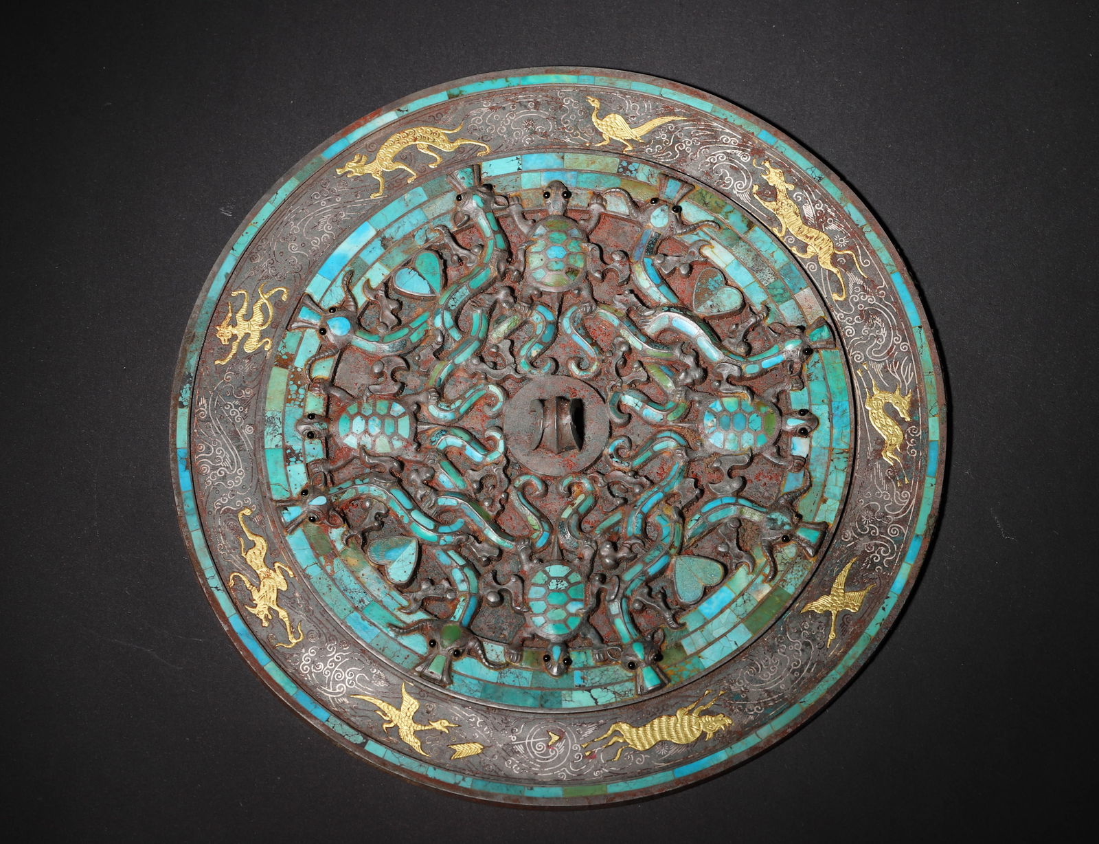 Han dynasty bronze mirror with gold-silver inlay & turquoise dragon-phoenix-turtle motifs: A rare han bronze mirror: exquisite gold-silver inlay & turquoise, dynamic dragon-phoenix-turtle motifs. Merging han bronze art peak & auspicious culture—a rare han mirror relic, highly valuable.Dia