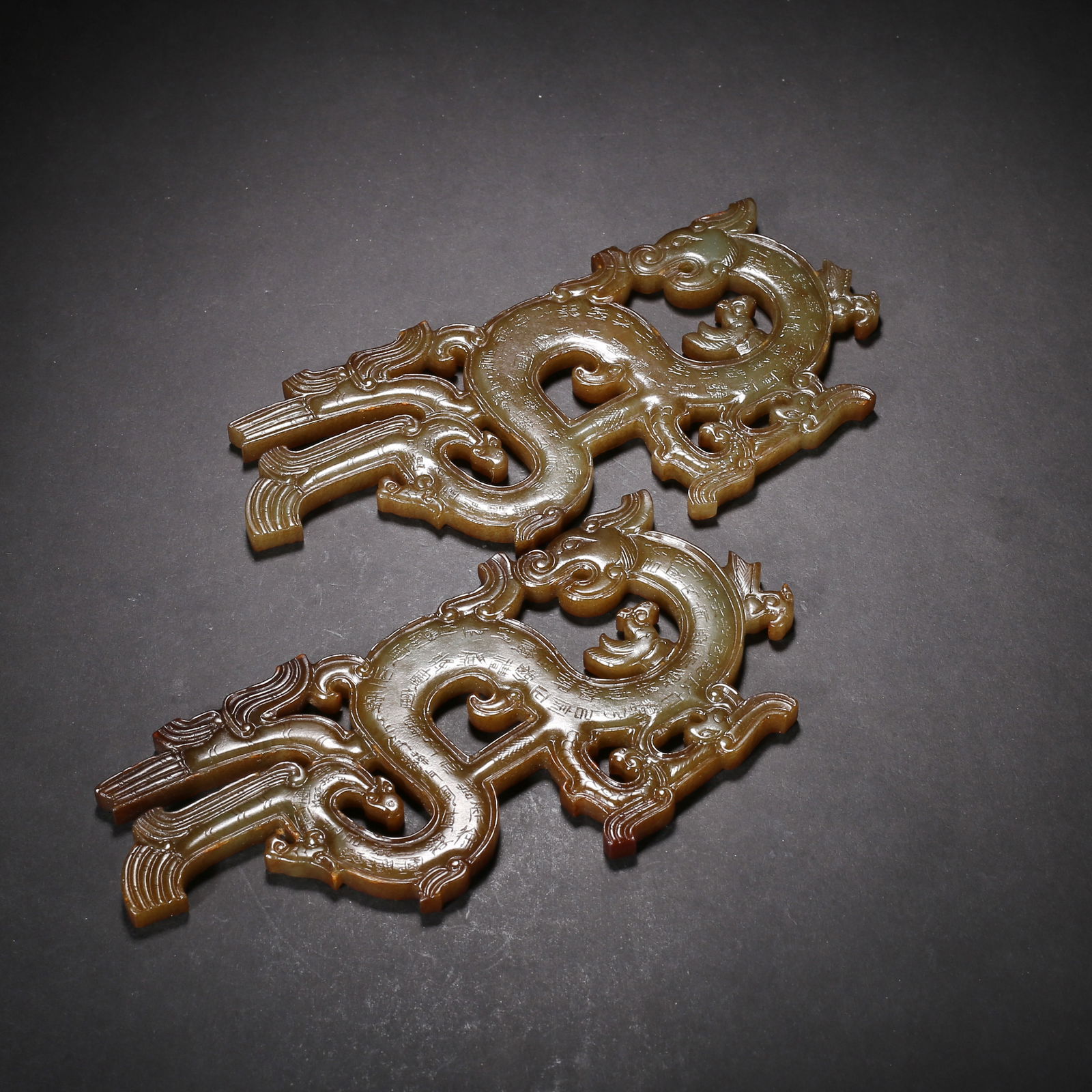 Warring states to han dynasty, a pair of yellow hetian jade pendants with openwork dragon and (1 of 3)