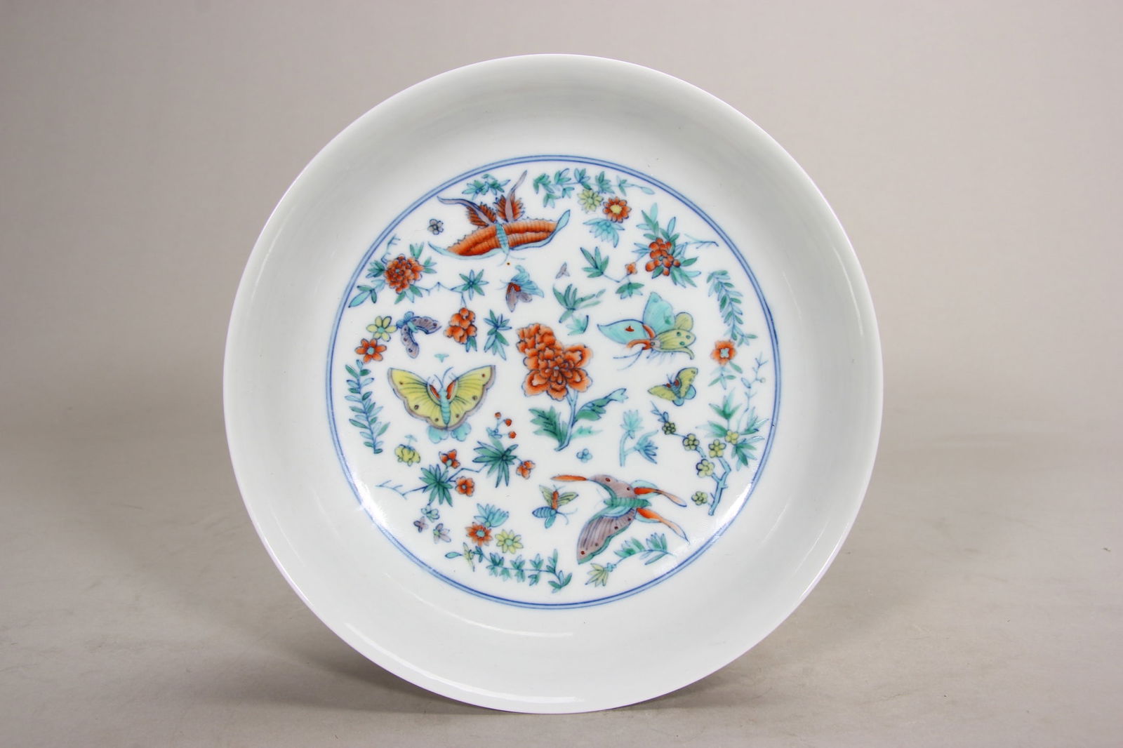 Qing dynasty yongzheng period, doucai dish with butterfly and floral design: An imperial doucai dish from the yongzheng period of the qing dynasty. Featuring vivid butterflies and floral motifs with delicate colors, bearing the "da qing yongzheng nian zhi" mark, it reflects th