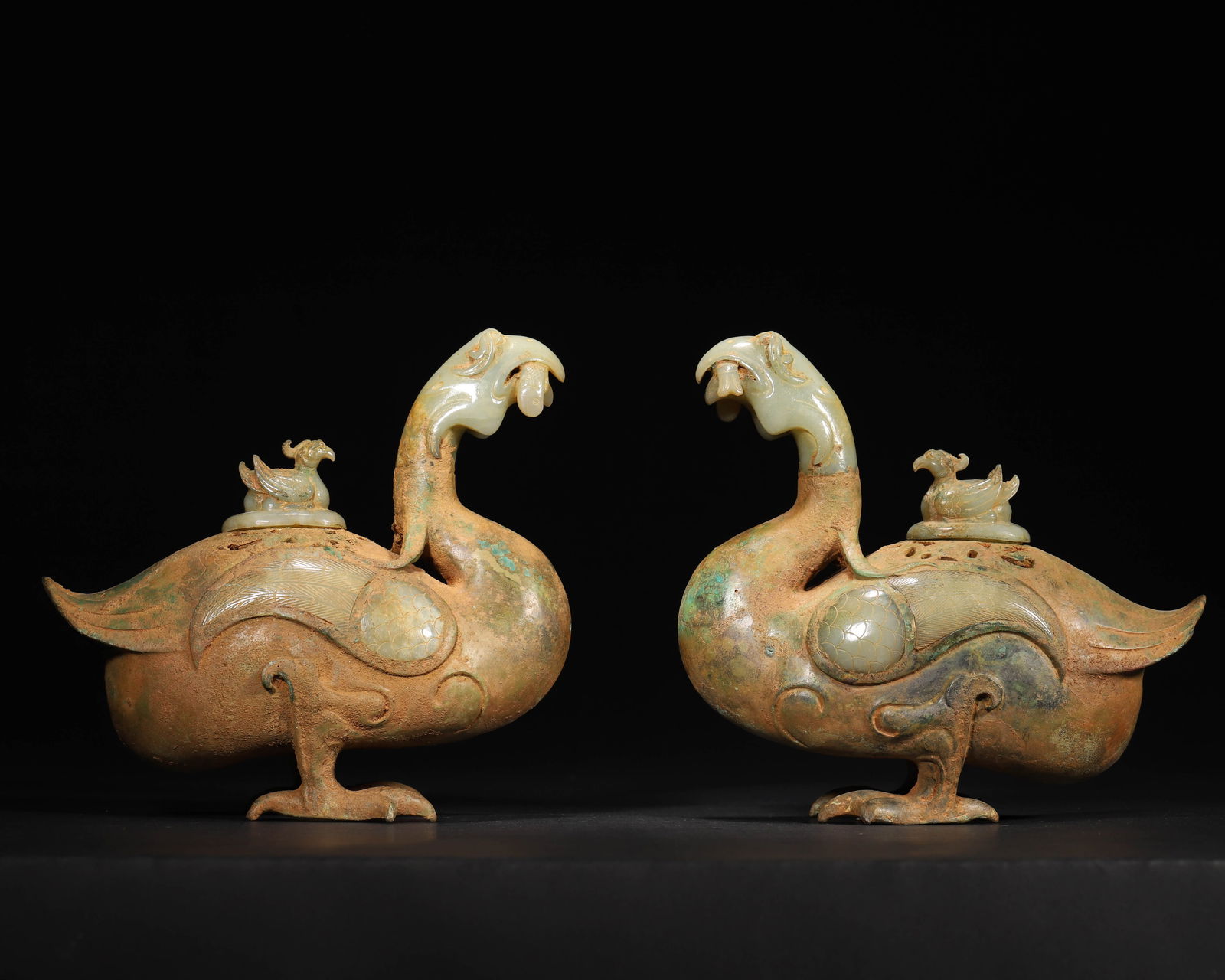 Pair of han dynasty bronze-and-jade phoenix incense burners: Pair of han dynasty incense burners shaped as phoenixes, inlaid with jade on body and jade phoenix knobs. Exquisite craftsmanship, vivid form—a rare han incense utensil of great historical and artis