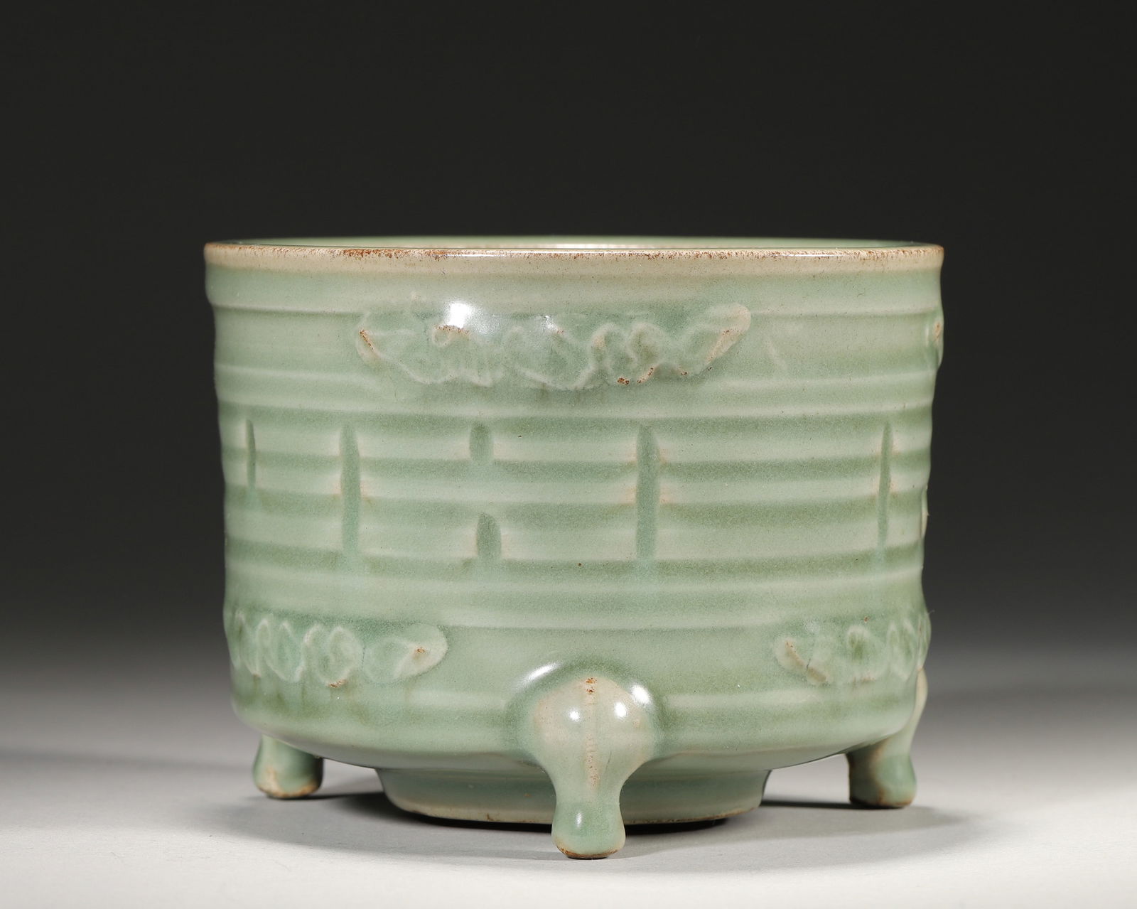 Song dynasty longquan kiln celadon tripod censer with bagua motifs: A fine song longquan censer: warm celadon glaze, carved with bagua & scroll motifs, neat tripod form. Merges song celadon craft with yi philosophy—rare example of artistic & cultural value,