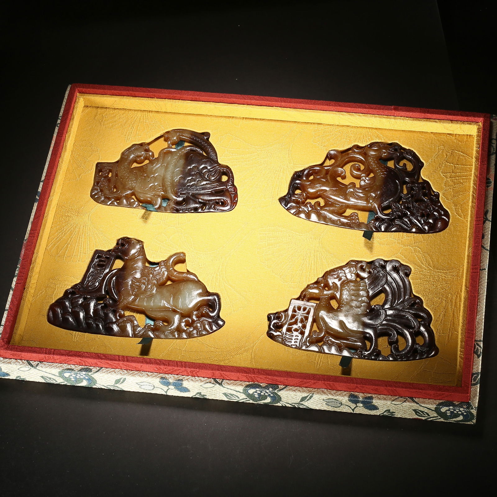 Han dynasty, a set of four hetian jade pendants with openwork dragon-horse, dragon-phoenix patterns: This set of four hetian jade pendants from the han dynasty features dynamic multi-layered openwork dragon-horse and dragon-phoenix motifs, with rich natural black patina. As core components of high-ra