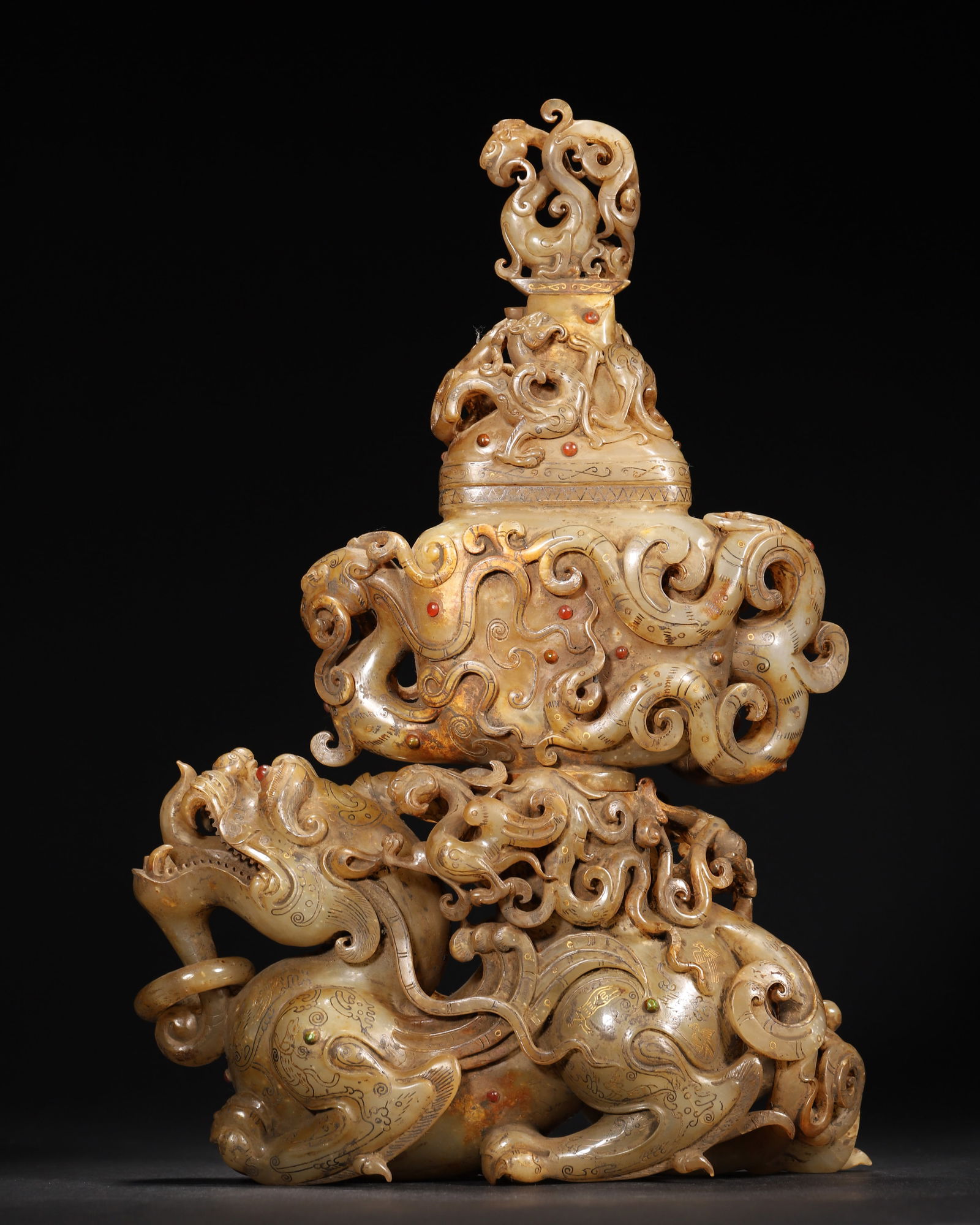 Han dynasty archaic jade gilt & gem-inlaid mythical beast vessel ornament: Han dynasty archaic jade ornament, made of patinated jade, with gilt cloud patterns and inlaid gems. Its mythical beast-bearing-vessel design, intricate openwork, embodies the peak of han jade inlay &