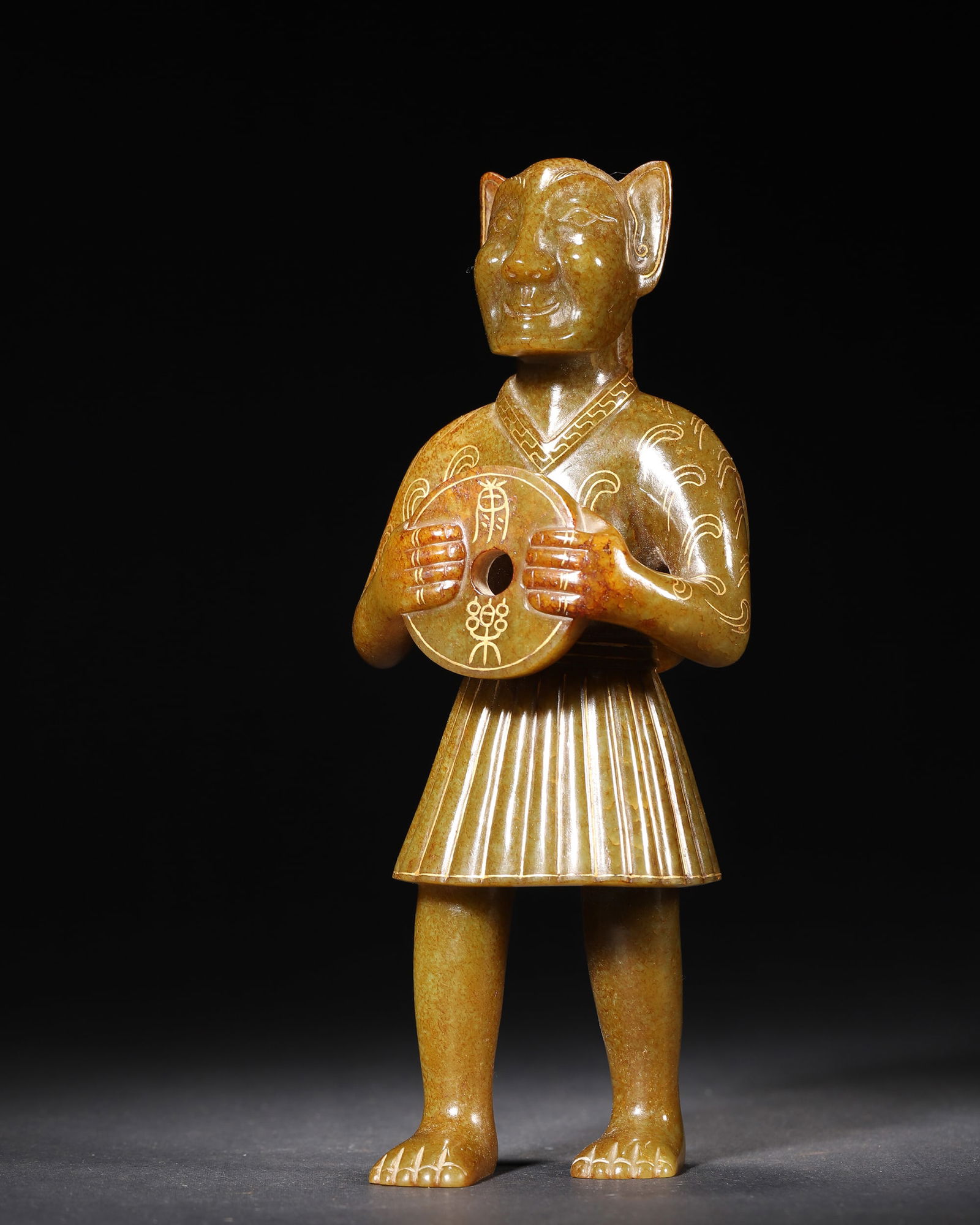 Han dynasty patinated yellow jade figure of beast-headed human holding bi disk: Han dynasty patinated yellow jade figure, with beast-head and human body (mythical beast motif), holding a carved bi disk. Its detailed attire patterns make it a rare han jade work blending myth and r
