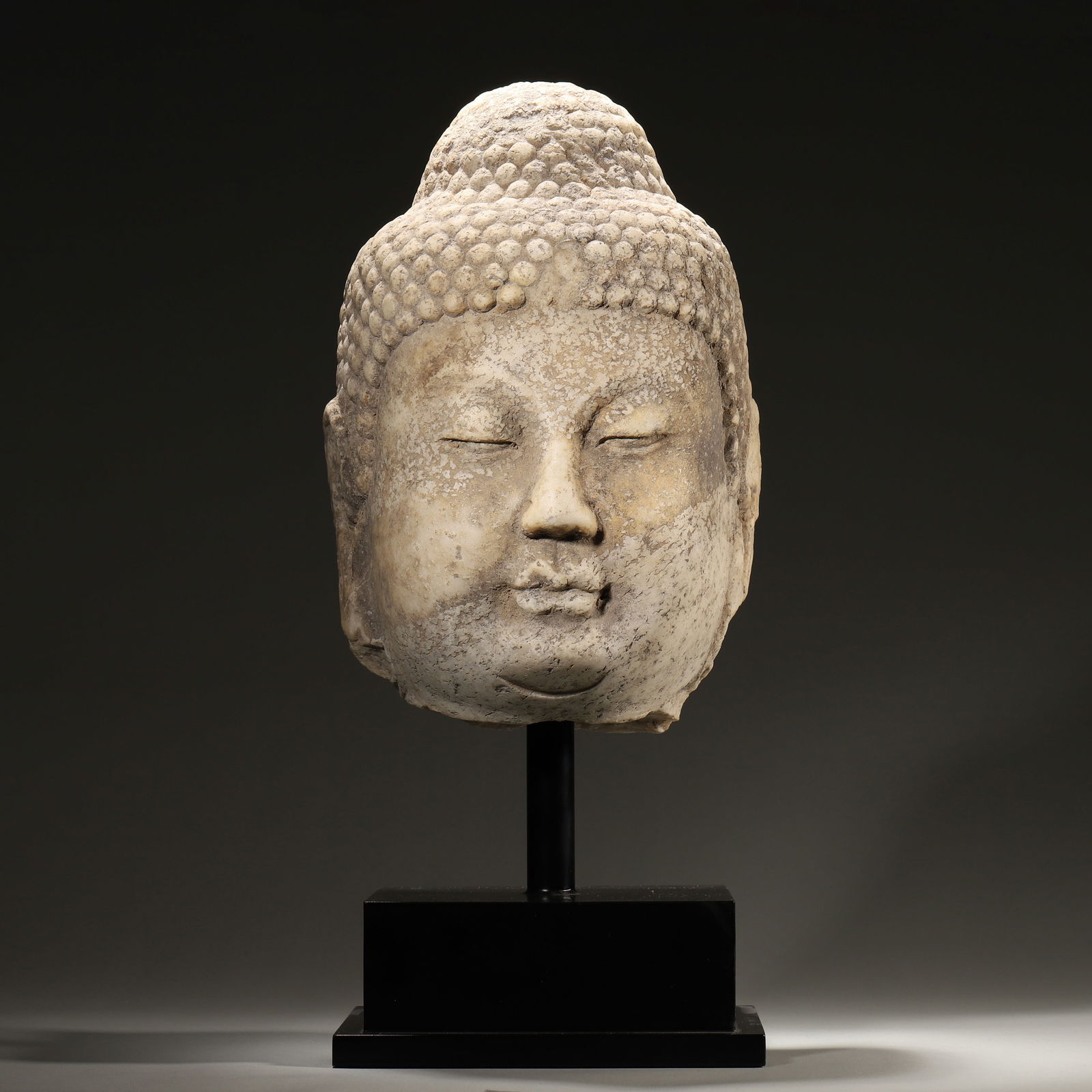 Tang dynasty, white marble buddha head: A masterpiece of tang dynasty buddhist sculpture, carved from white marble with a spiral ushnisha and serene expression. It reflects the pinnacle of tang buddhist art, holding great historical and art