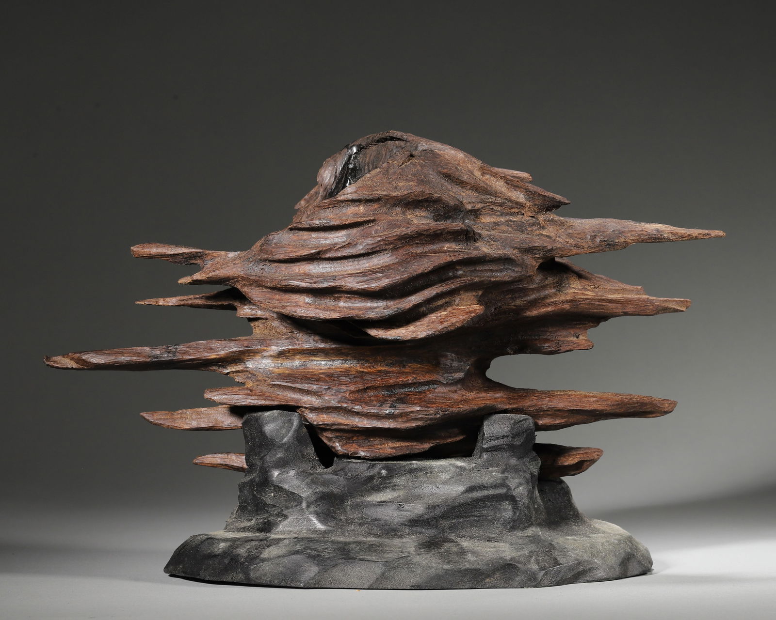Qing dynasty agarwood bonsai-style ornament (natural form): Natural agarwood carved to follow its shape, layered & stretching like flowing clouds peaks; Paired with a stone base. Fully embodies the literati aesthetic of "natural charm". Follows ming-qing schol