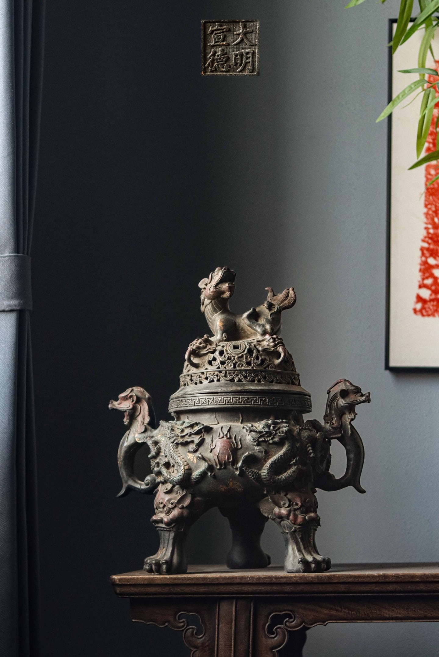 MING DYNASTY XUANDE DOUBLE DRAGON PLAYING WITH A PEARL THREE-LEGGED BEAST EAR INCENSE BURNER: Weight:8500gH:45cm W:38cm T:26cm This is a copper three-legged animal-shaped incense burner with a dragon pattern, which is a classic form in traditional Chinese incense wares.