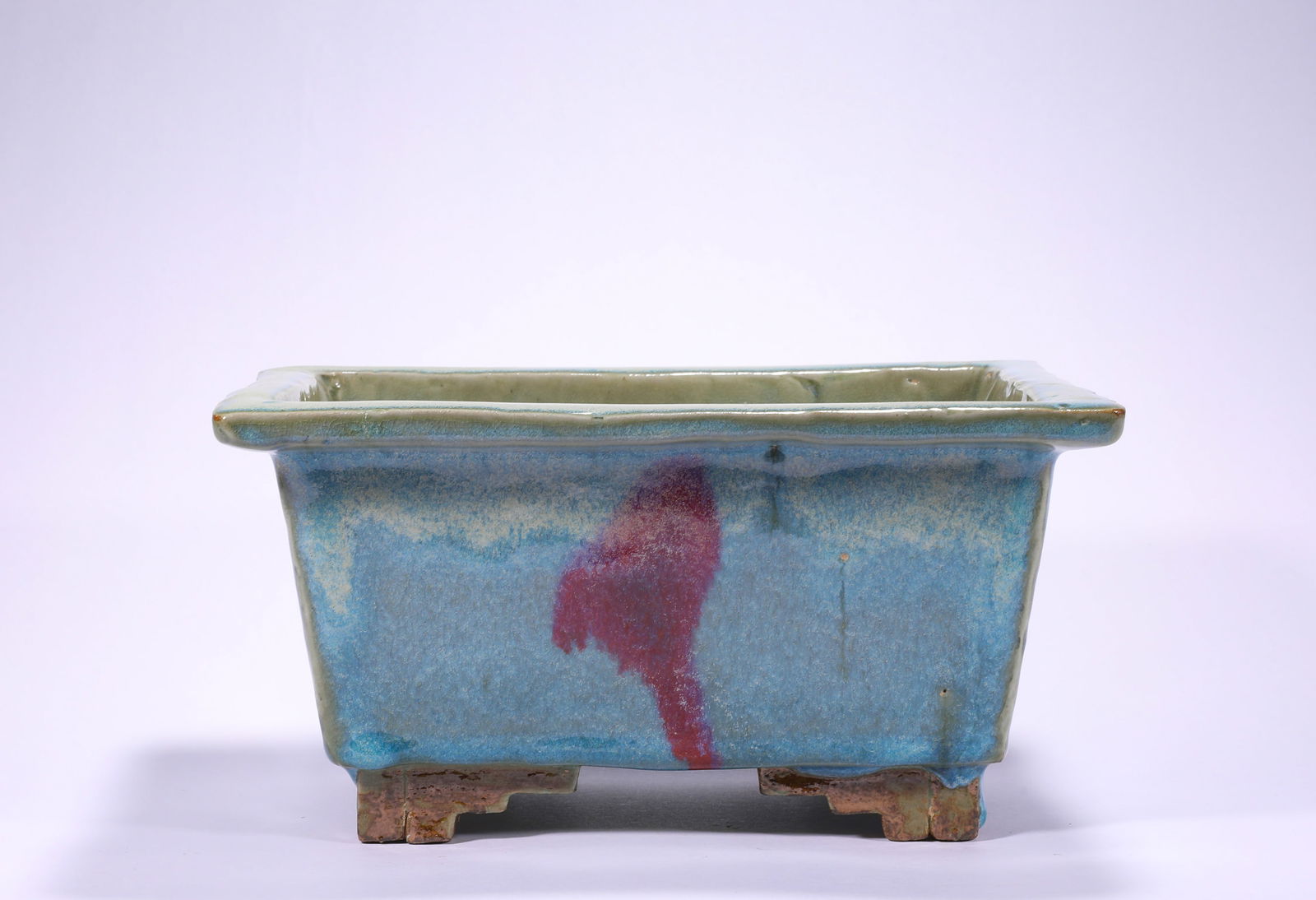 SONG DYNASTY, JUN KILN FOUR-LEGGED PEN WASH: H:12cmW:23.5cm This is a rectangular basin with sky blue glaze and purple spots from the Jun Kiln of the Song Dynasty. It is a typical court vessel of the Jun Kiln, one of the five famous kilns of the