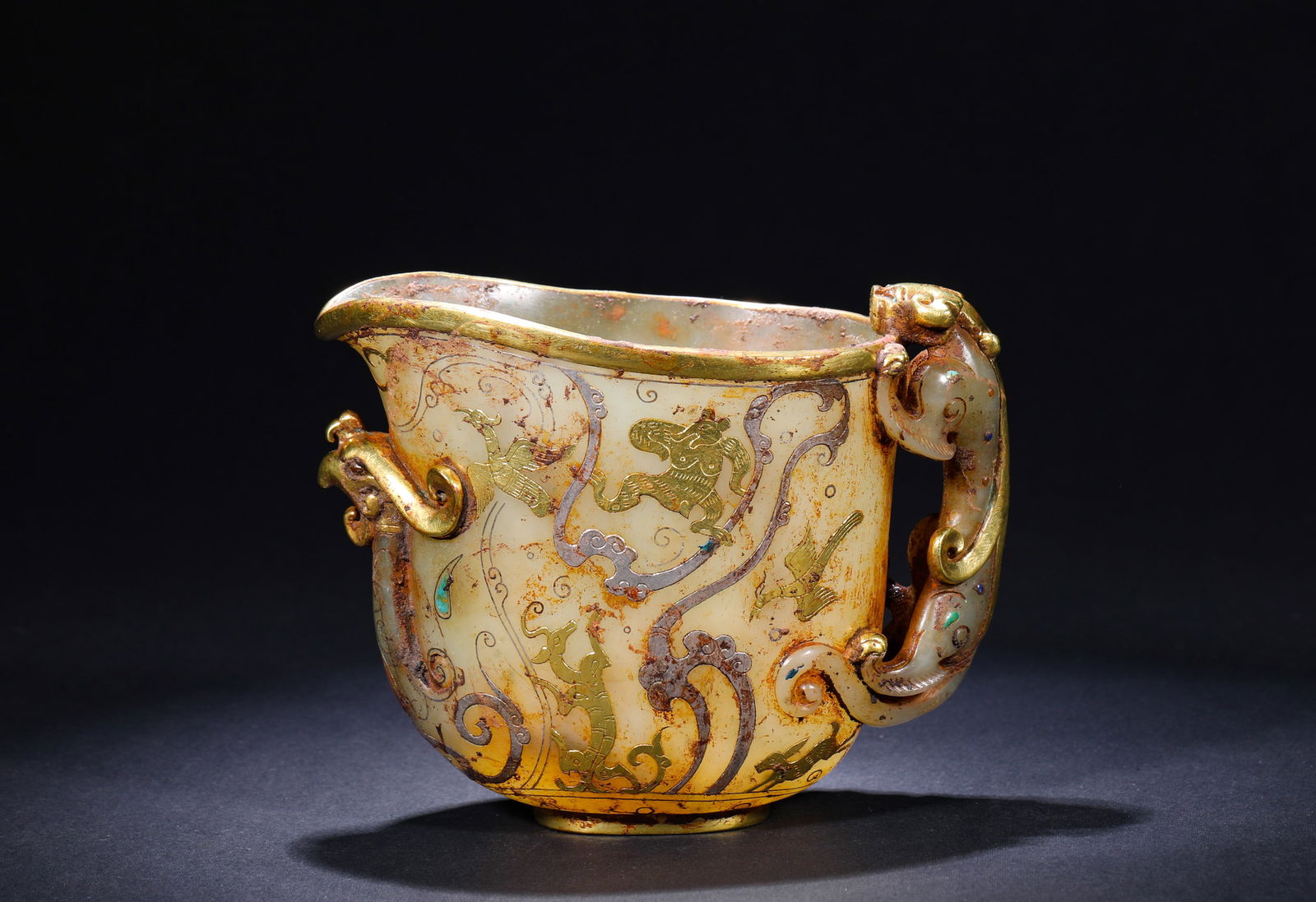 HAN DYNASTY HETIAN JADE GOLD AND SILVER CUPS: H:11cmW:13.5cmWeight:370g This is a Han Dynasty jade cup with inlaid gold and silver wires (inlaid gold and silver) and a chilong-patterned horn, representing the pinnacle of the combination of Han Dy
