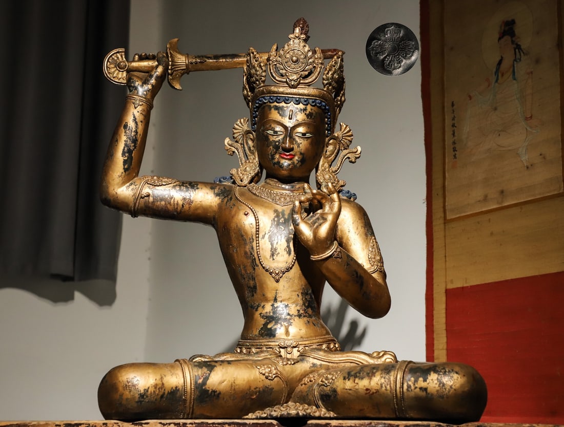 A GILDED BRONZE STATUE OF MANJUSRI BODHISATTVA HOLDING A SWORD IN THE QING DYNASTY: Weight:23000g.H:72cmL:56cmW:35cm This is a gilded bronze seated statue of Manjushri Bodhisattva from the Ming Dynasty, a representative Buddhist sculpture embodying the integration of Han and Tibetan
