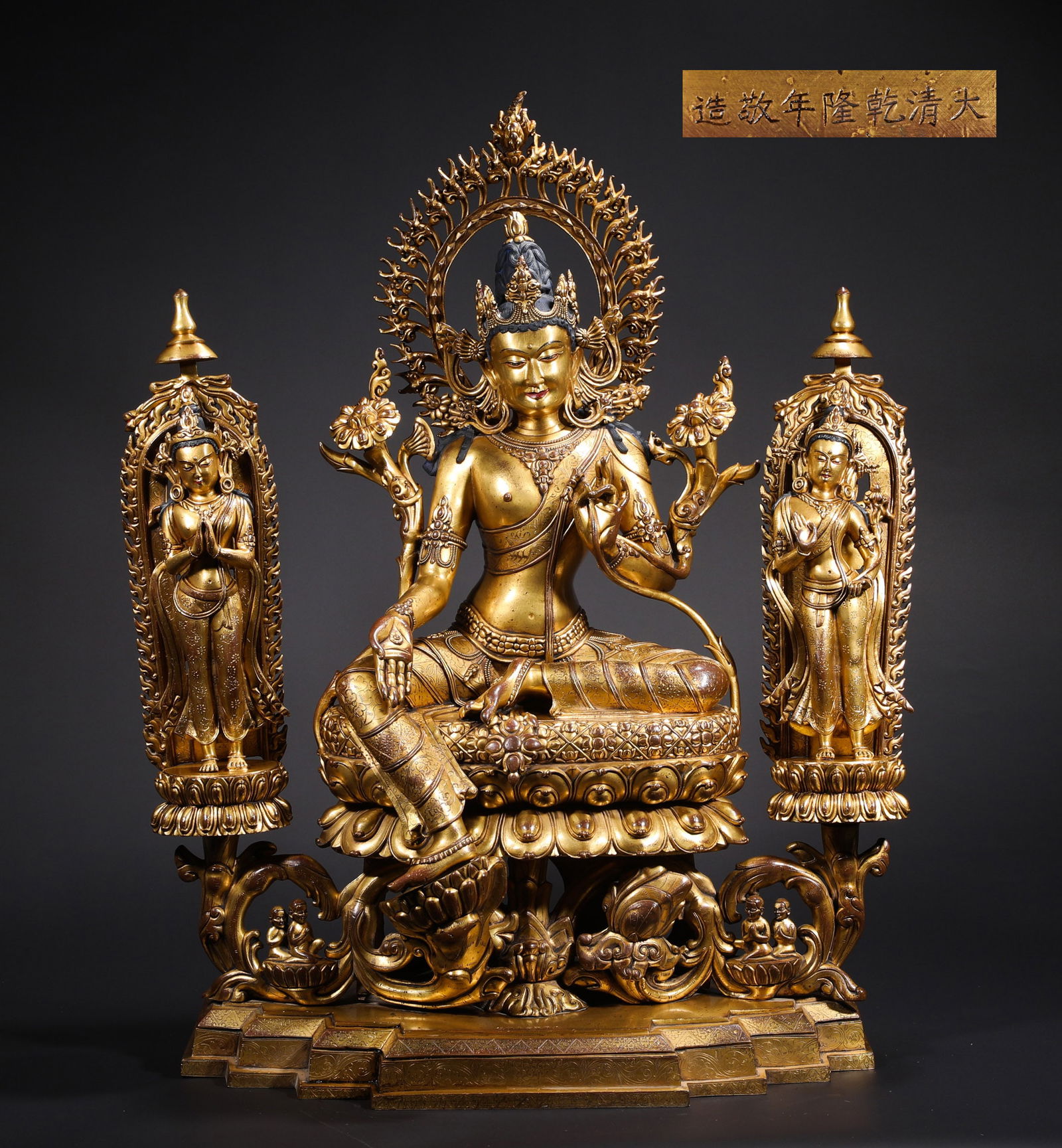 A BRONZE GILDED BUDDHA STATUE BY EMPEROR QIANLONG OF THE QING DYNASTY: H:78cmW:56cmWeight:45500g This is a set of three gilded bronze statues of Guanyin in Royal Ease Pose from the Qianlong period of the Qing Dynasty, a top-tier treasure of imperial Tibetan Buddhist scul