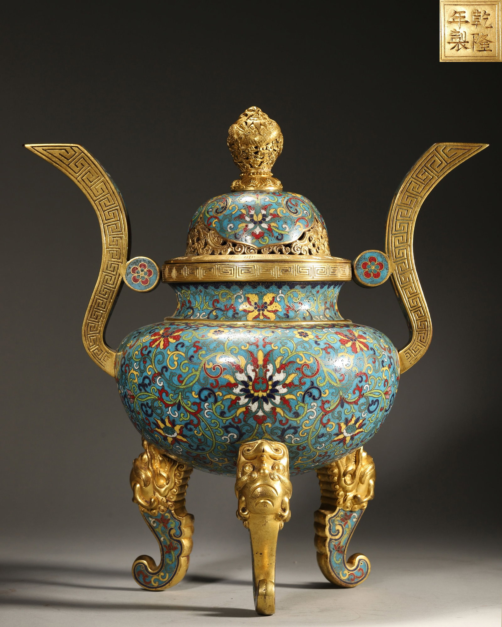 QING DYNASTY, QIANLONG MARK, CLOISONNÉ ENAMEL ON COPPER TRIPOD CENSER: Height 37.0cm (14.57in), Weight 3770.0g (8.31lb)Imperially made by the Imperial Workshop. The censer body is fully decorated with interlocking branch patterns. The cloisonné colors are brilliant, the
