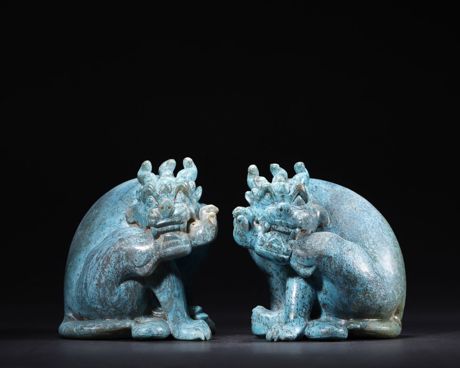 HAN DYNASTY, A PAIR OF HETIAN JADE MYTHICAL BEASTS WITH BLUE ANCIENT CALCIFICATION: 3.54" x 3.15" x 4.33" inches (9.0 cm x 8.0 cm x 11.0 cm) | Weight: 4.35 lbs (1973.0 g)Carved from Hetian jade with rare thousand-year natural copper-blue calcification infiltrated deeply. A noble Han
