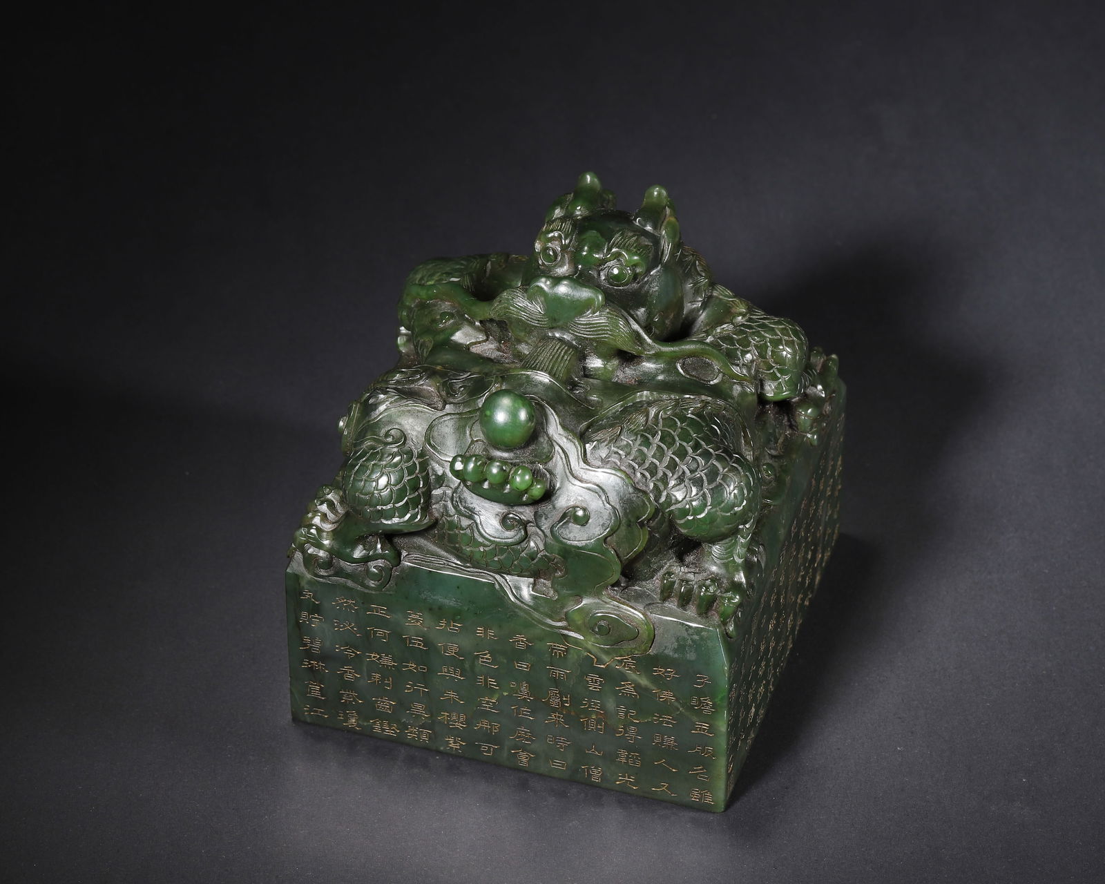 AN IMPERIAL HETIAN JASPER SEAL WITH DRAGON KNOP AND INSCRIBED IMPERIAL POEMS, MARK AND PERIOD OF: 4.57" x 4.57" x 4.57" inches (11.6 cm x 11.6 cm x 11.6 cm) | Weight: 6.51 lbs (2953.0 g)This imperial Hetian jasper seal from Qing Qianlong period features a masterfully carved dragon knop, inscribed