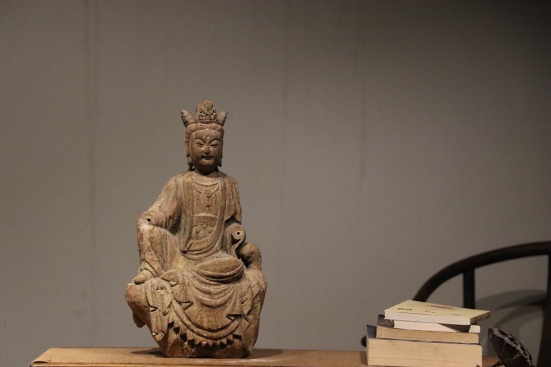 A FINE CARVED WOOD SEATED GUANYIN IN ROYAL EASE POSE, MING DYNASTY, 14TH–17TH CENTURY AD: Height: 17.72" inches (45.0 cm)Though the hands are incomplete, the figure retains its graceful charm and enduring spiritual presence. With smooth, exquisitely flowing carving lines, it is ideal for b