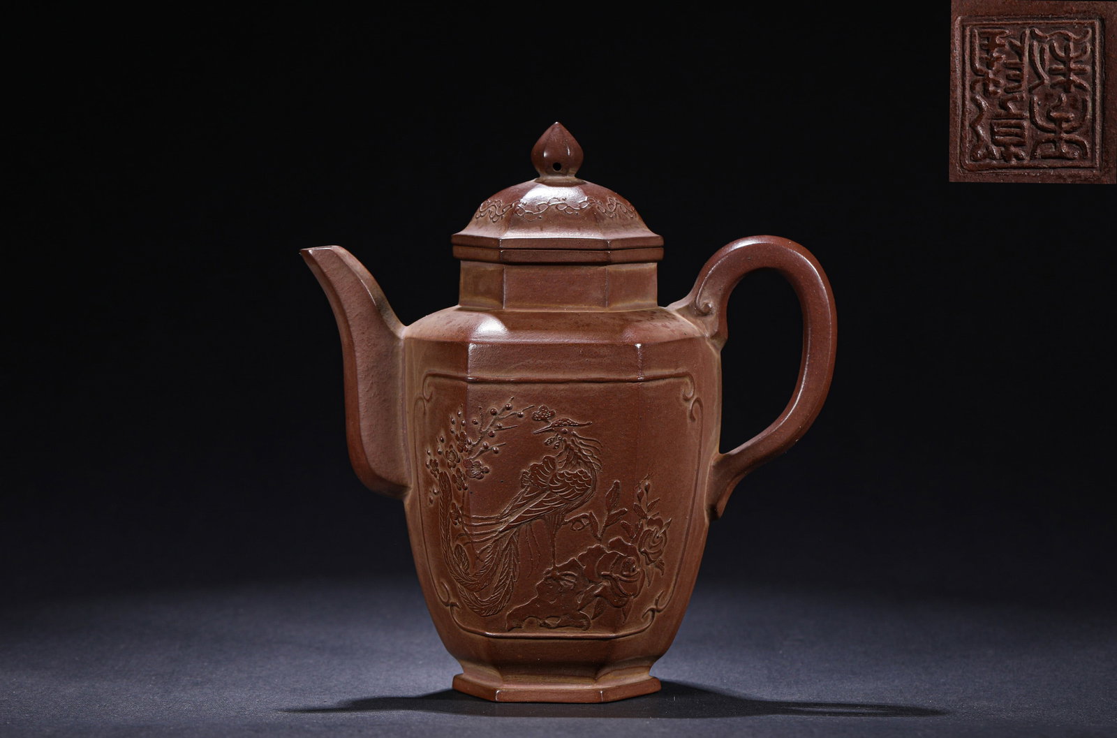 A HEXAGONAL PURPLE CLAY TEAPOT WITH FLORAL AND BIRD PATTERNS FROM THE QING DYNASTY: H:16cmW:14cm This is a hexagonal Yixing clay teapot with applied bird-and-flower patterns from the Qing Dynasty. Made of purple clay, it features a hexagonal body and lid, with an openwork window of
