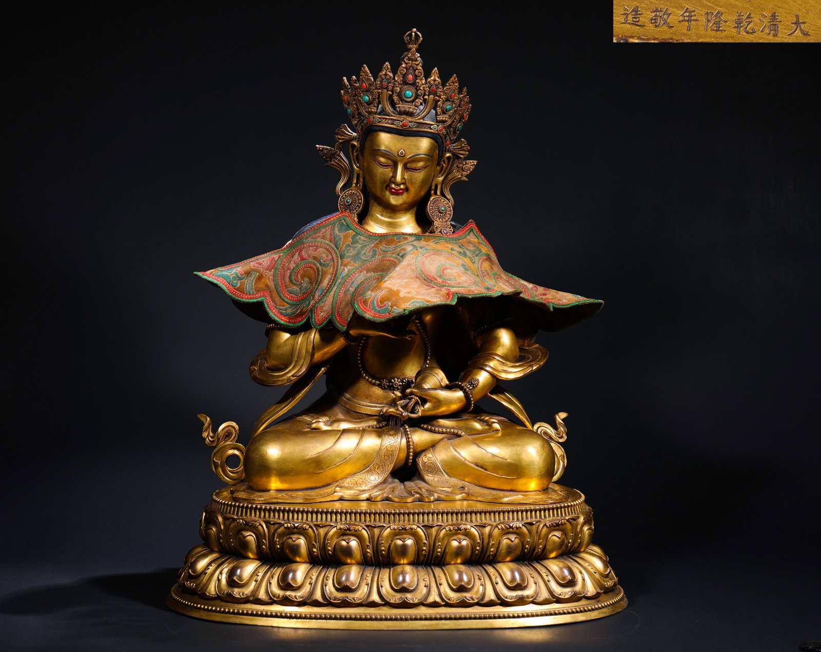 IN THE REIGN OF EMPEROR QIANLONG OF THE QING DYNASTY, A GILDED BRONZE STATUE OF VAJRASATTVA ? WAS: H:63cmW:45cmWeight:21450g This is a gilt-bronze seated statue of Vajrasattva, marked with "Made respectfully in the Qianlong reign of the Great Qing Dynasty". Cast in bronze and fully gilded, the Bodh