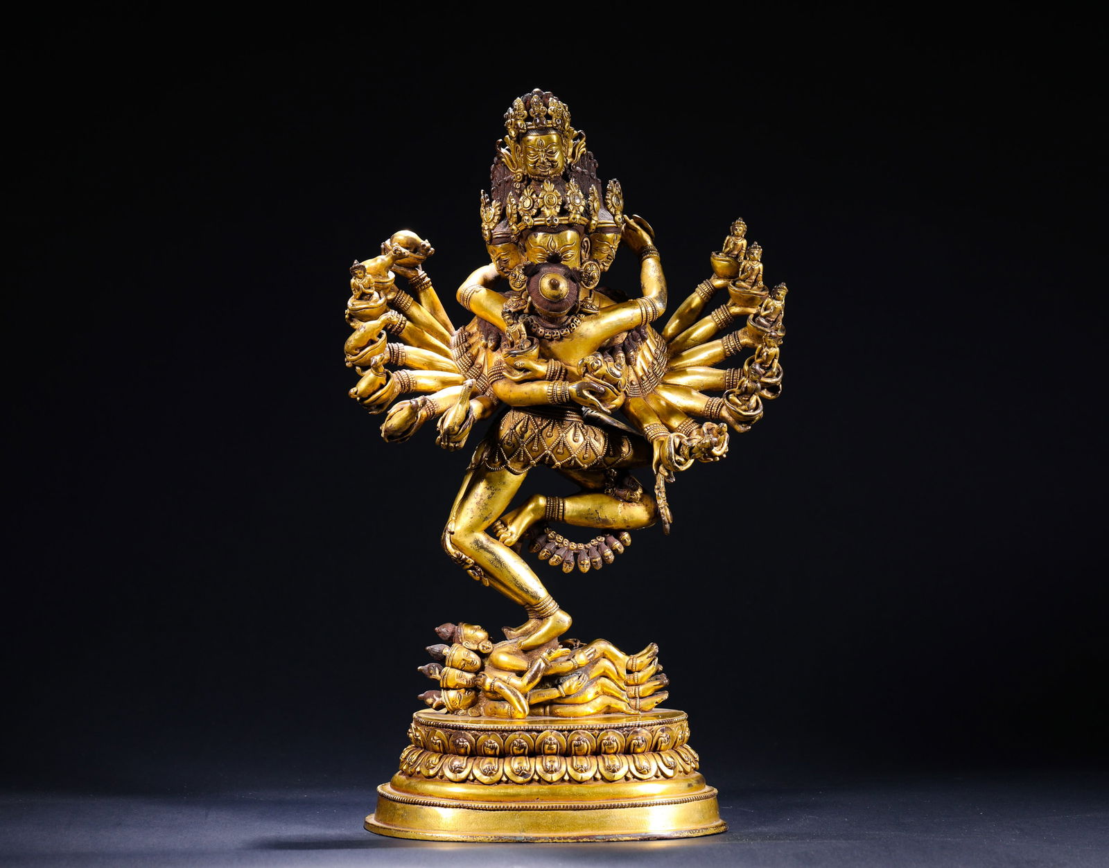 BRONZE GILDED VAJRA DOUBLE FIGURES FROM THE QING DYNASTY: H:41cmW:23cmWeight:7950g This is a gilt-bronze statue of Kalachakra in Yab-Yum (union form). Cast in bronze and fully gilded, the main deity Kalachakra has multiple heads and arms, embracing his