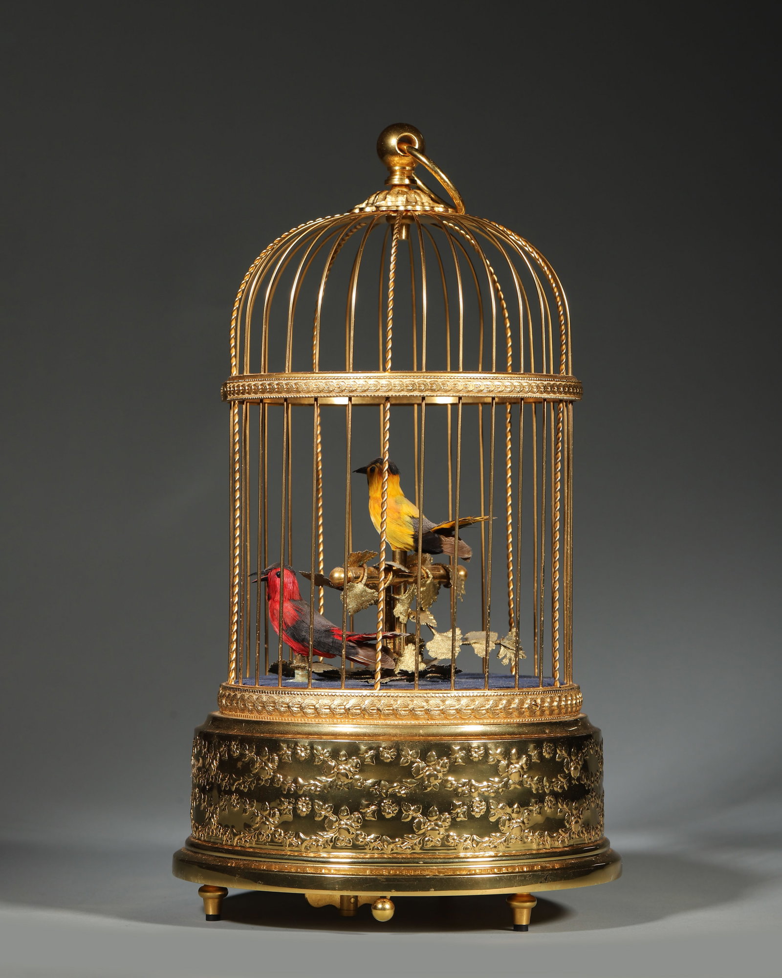 SWISS REUGE DOUBLE SINGING BIRD MUSIC BOX: 5.91in x 11.42in (15.0cm x 29.0cm) | 3.228lb (1464g)Swiss REUGE Double Singing Bird Music Box. Crafted with a gilt-bronze arched birdcage, two exquisitely detailed birds perch on a branch, ready to si