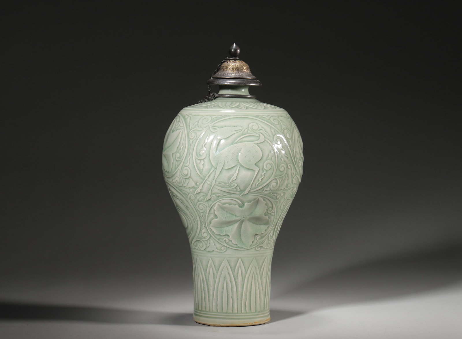 A SONG DYNASTY LONGQUAN CELADON GLAZED PLUM VASE WITH SILVER GILT LID: Diameter: 14.5cm (5.71in) H: 28cm (11.02in)A fine Song Dynasty Longquan celadon glazed meiping (plum vase), carved with beast and gourd motifs, silver gilt lid, natural patina, exquisite craftsmanship