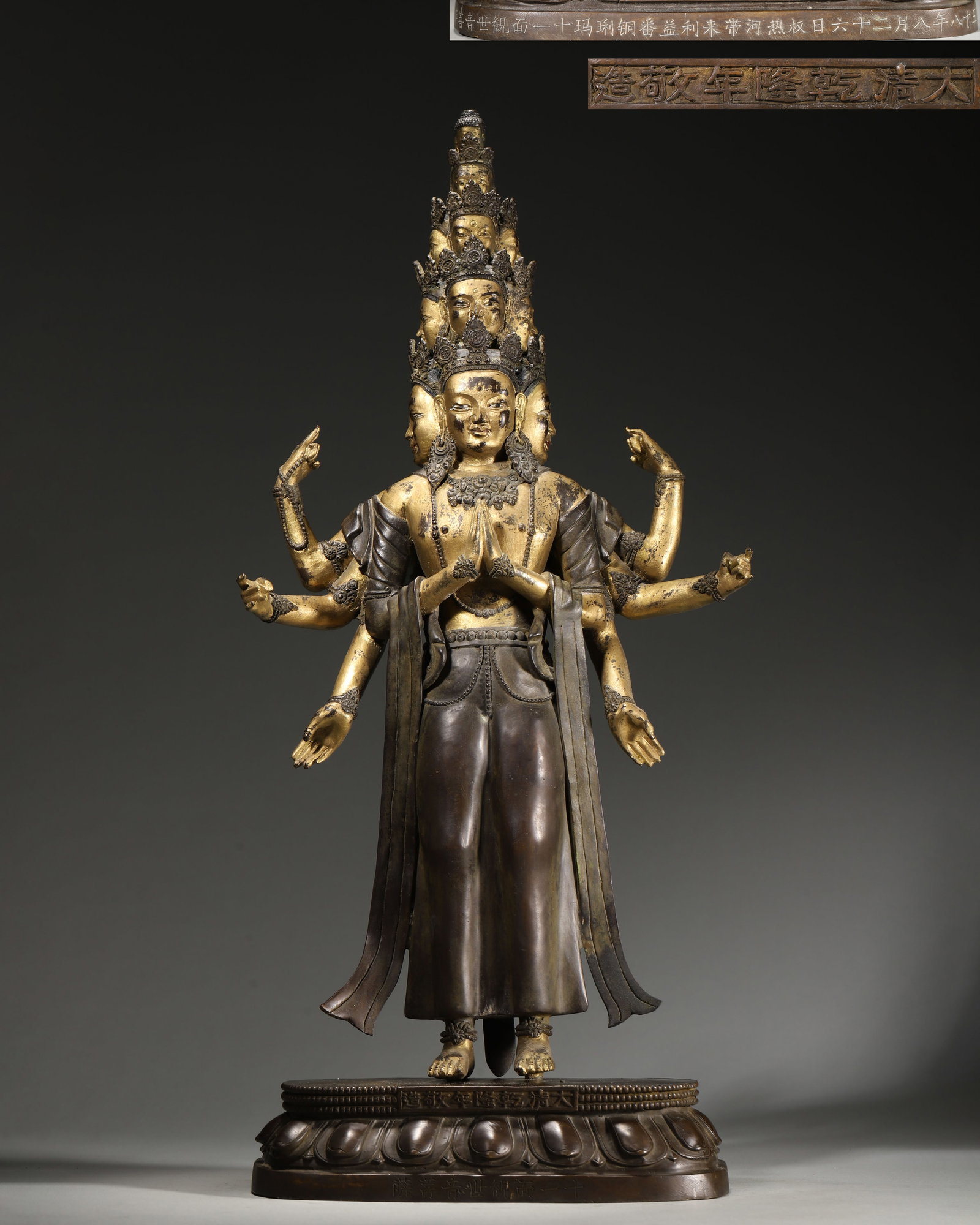 IMPERIAL QIANLONG PERIOD, QING DYNASTY GILT-BRONZE STANDING STATUE OF ELEVEN-FACED AVALOKITESHVARA: 7.87" x 3.94" x 18.9" (20cm x 10cm x 48cm) | 11.37lb (5156g)An imperial Qianlong-period gilt-bronze standing Eleven-Faced Avalokiteshvara, with eleven stacked heads and multiple arms. Bearing dated Qi