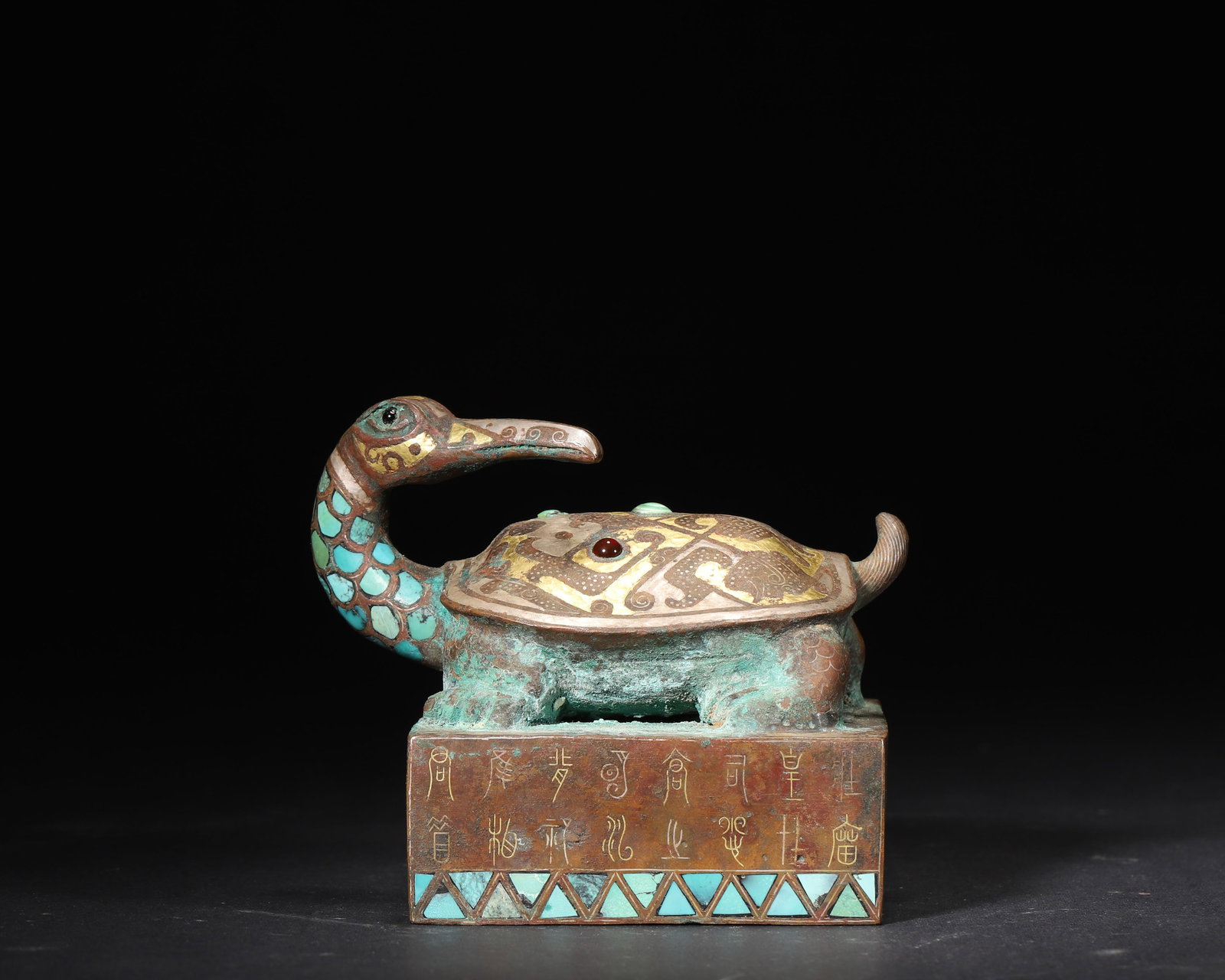HAN DYNASTY GILT-BRONZE SEAL WITH INLAID GOLD, SILVER, TURQUOISE AND GEMSTONES, CARVED WITH: 3.74in x 2.95in x 3.15in (9.5cm x 7.5cm x 8.0cm), 1.931lb (876.0g)A Han Dynasty bronze seal, featuring a unique turtle-crane (Xuanwu) knob inlaid with gold, silver, turquoise and gemstones. The square