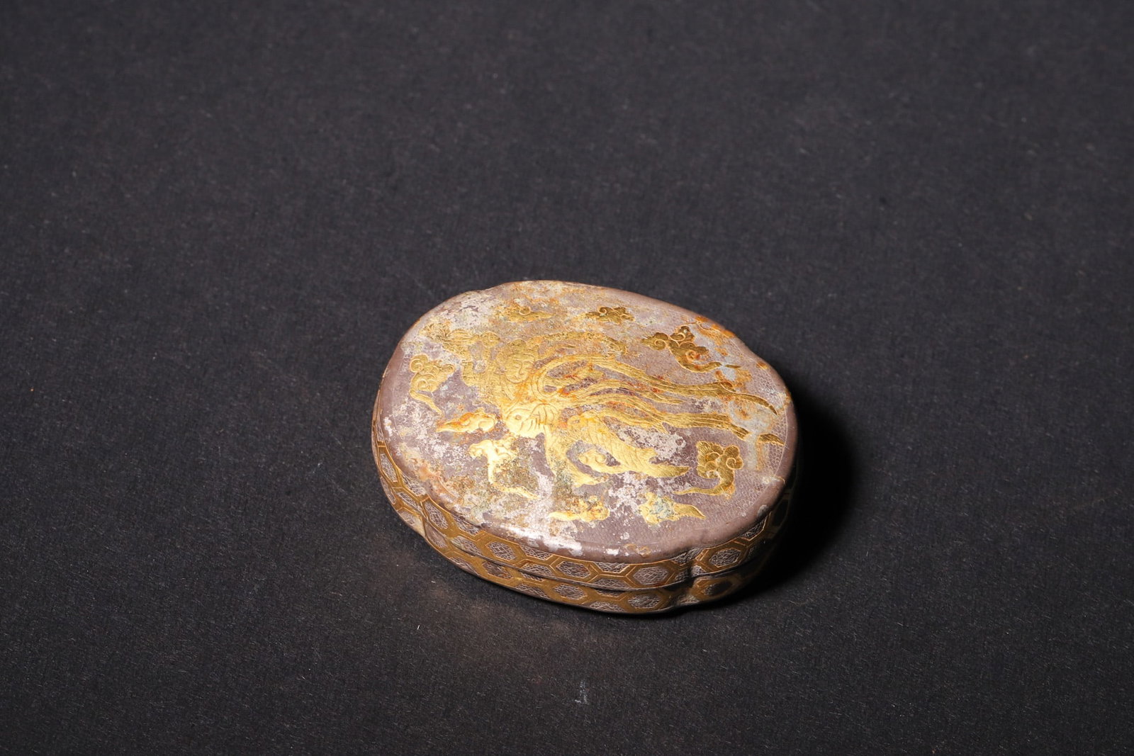 A Tang Dynasty Silver Gilt Incense Box with Phoenix Pattern: Length 4.0cm (1.57in), Width 3.0cm (1.18in), Height 1.5cm (0.59in), Weight 7.0g (0.02lb)A Tang Dynasty silver gilt incense box, exquisitely engraved with phoenix and flower patterns on the lid, and to