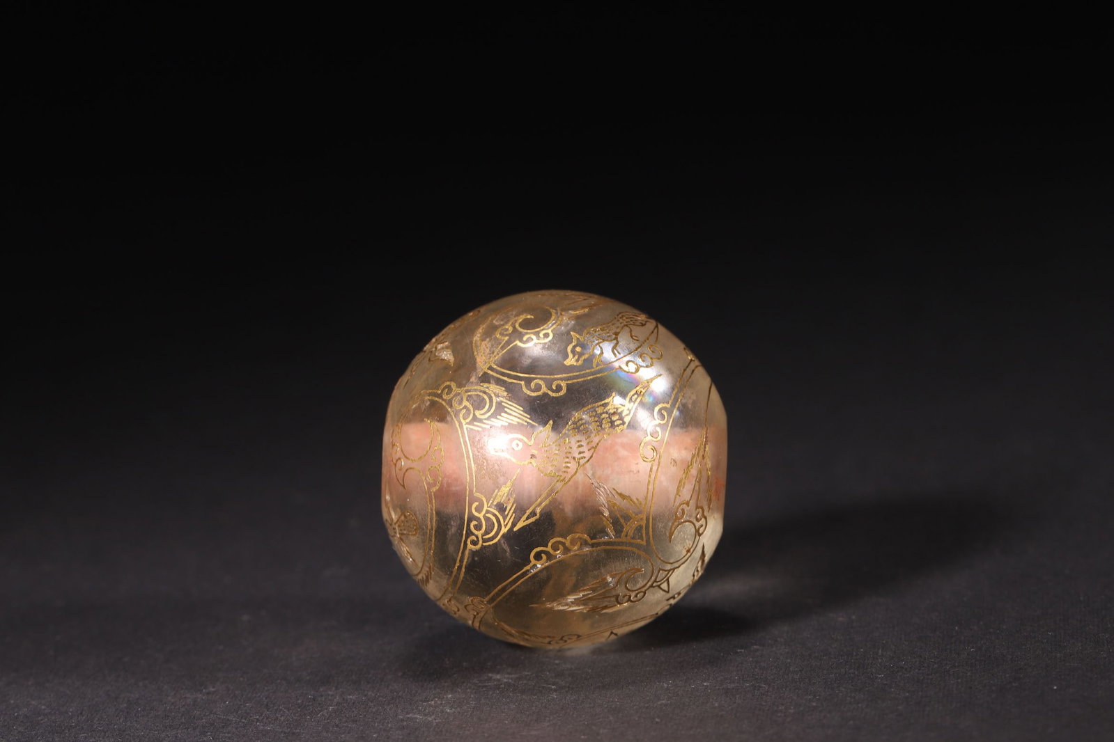 A Han Dynasty Crystal Bead with Gold Inlaid Auspicious Beast Pattern: Diameter 3.8cm (1.5in), Weight 75.0g (0.17lb)A Han Dynasty crystal bead, decorated with gold inlaid auspicious beast patterns. With exquisite craftsmanship, it reflects the superb level of Han Dynasty