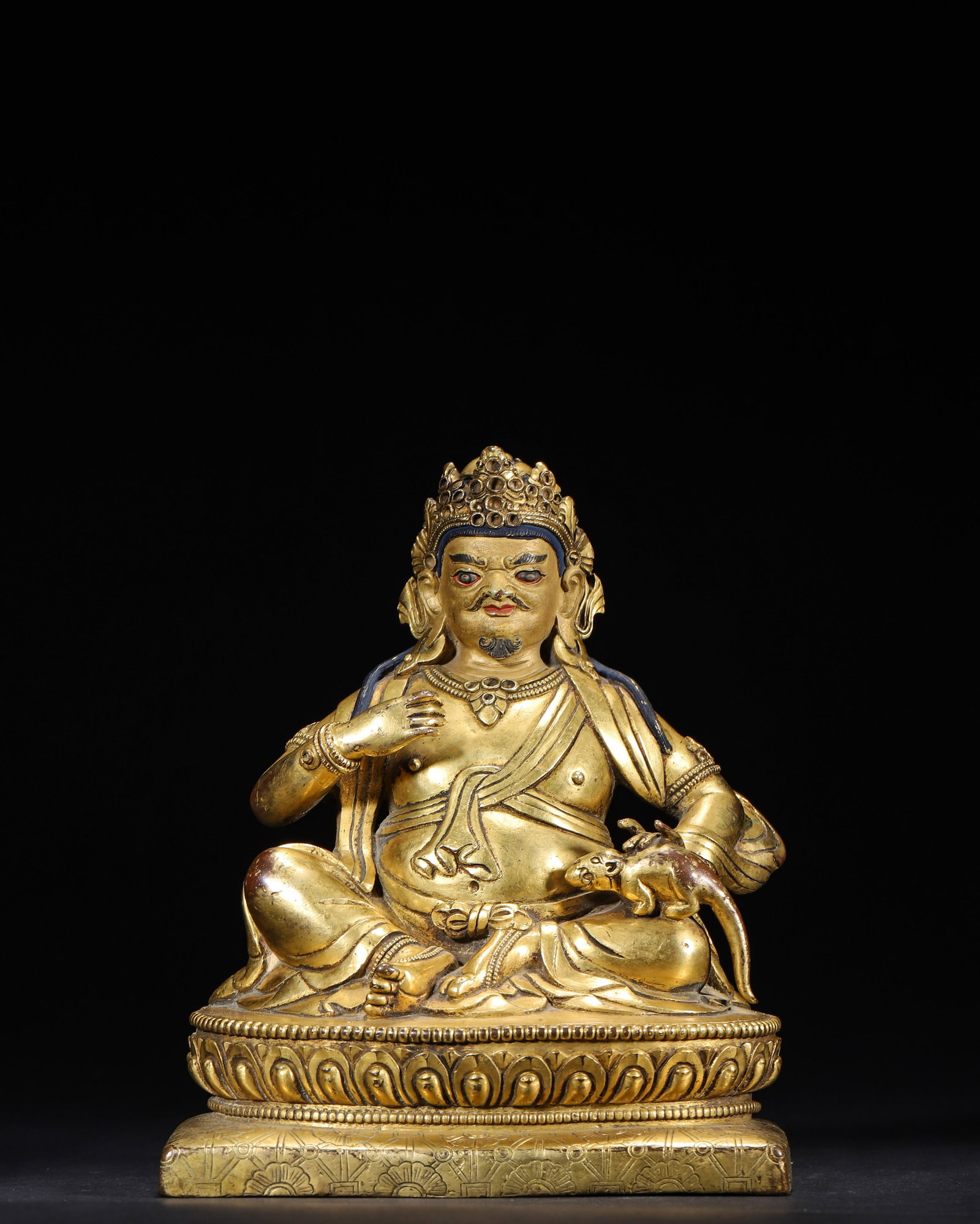 A Gilt-Bronze Figure of Yellow Jambhala, Qing Dynasty: 2053.0 g (4.53 lb) | 13.0 x 10.0 x 17.0 cm (5.12 x 3.94 x 6.69 in)This fine Qing Dynasty Tibetan gilt-bronze figure of Yellow Jambhala is seated in relaxed posture, wearing a precious crown with a maj