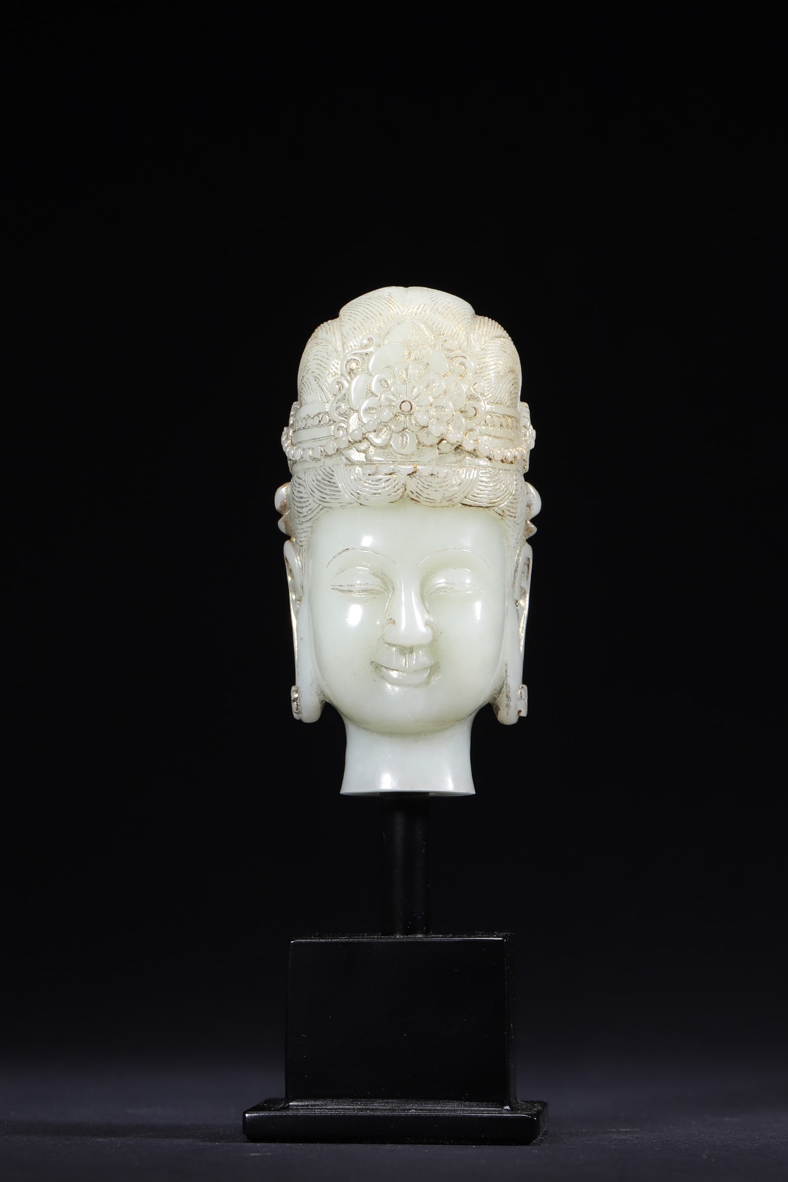 A Hetian White Jade Guanyin Head with Gilded Details, Qing Dynasty: Length 4.4cm (1.73in), Width 4.0cm (1.57in), Height 8.4cm (3.31in), Weight 206.0g (0.45lb)This is a Qing Dynasty Hetian white jade Guanyin head with gilded details. Carved with serene features and orn