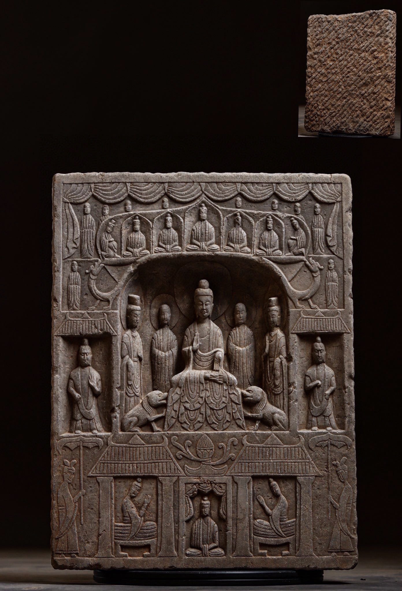 A Limestone Buddhist Stele, Northern Dynasties: Height 50cm (19.69 in); Width 38cm (14.96 in); Thickness 8cm (3.15 in)A Northern Dynasties limestone Buddhist stele with multi-tiered carvings. The central niche enshrines the preaching Buddha,
