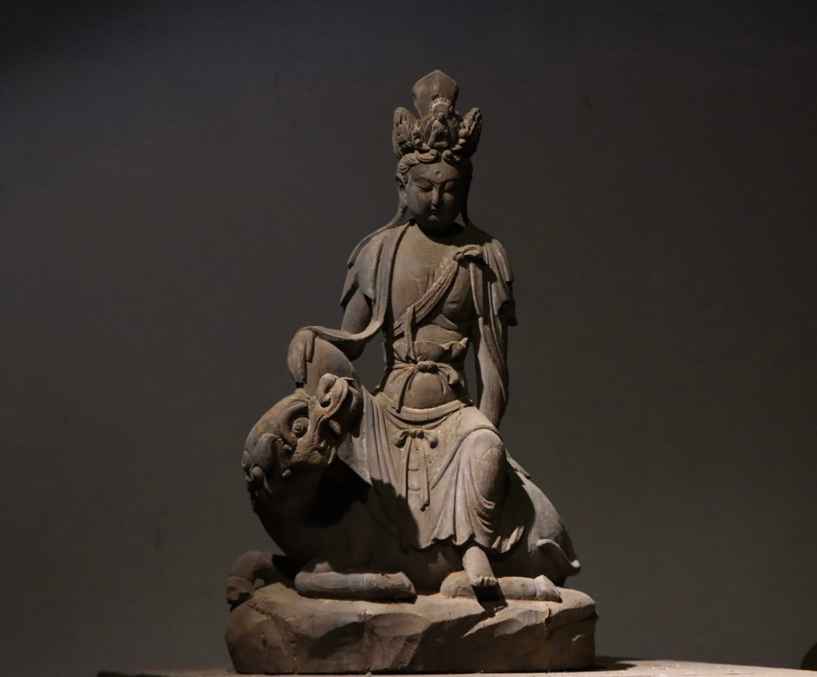 A Wood Figure of Manjushri - Song Dynasty: Height 60cm (23.62 in)This wood figure of Manjushri dates to the Song Dynasty. The serene Bodhisattva sits gracefully on a lion mount, embodying the refined grace of Song Buddhist art.