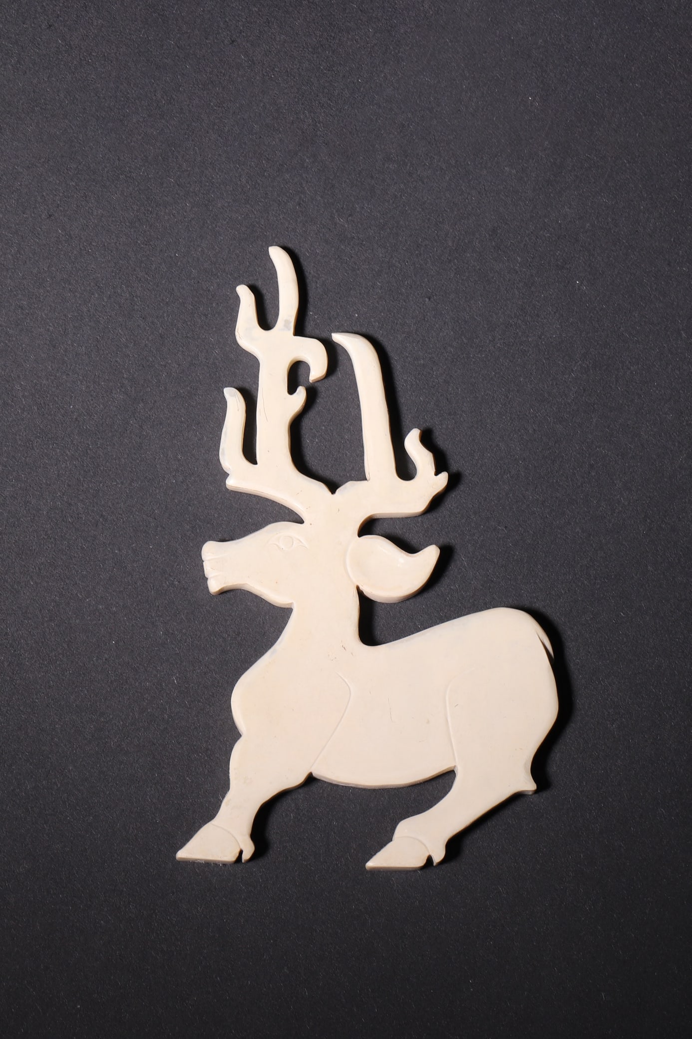 An Ancient Jade Deer Pendant - Han Dynasty: Length 5.5cm (2.17in), Height 9.0cm (3.54in), Weight 21.0g (0.05lb)This deer-shaped pendant is elaborately carved from ancient jade, featuring a vivid running posture with smooth lines. With natural p